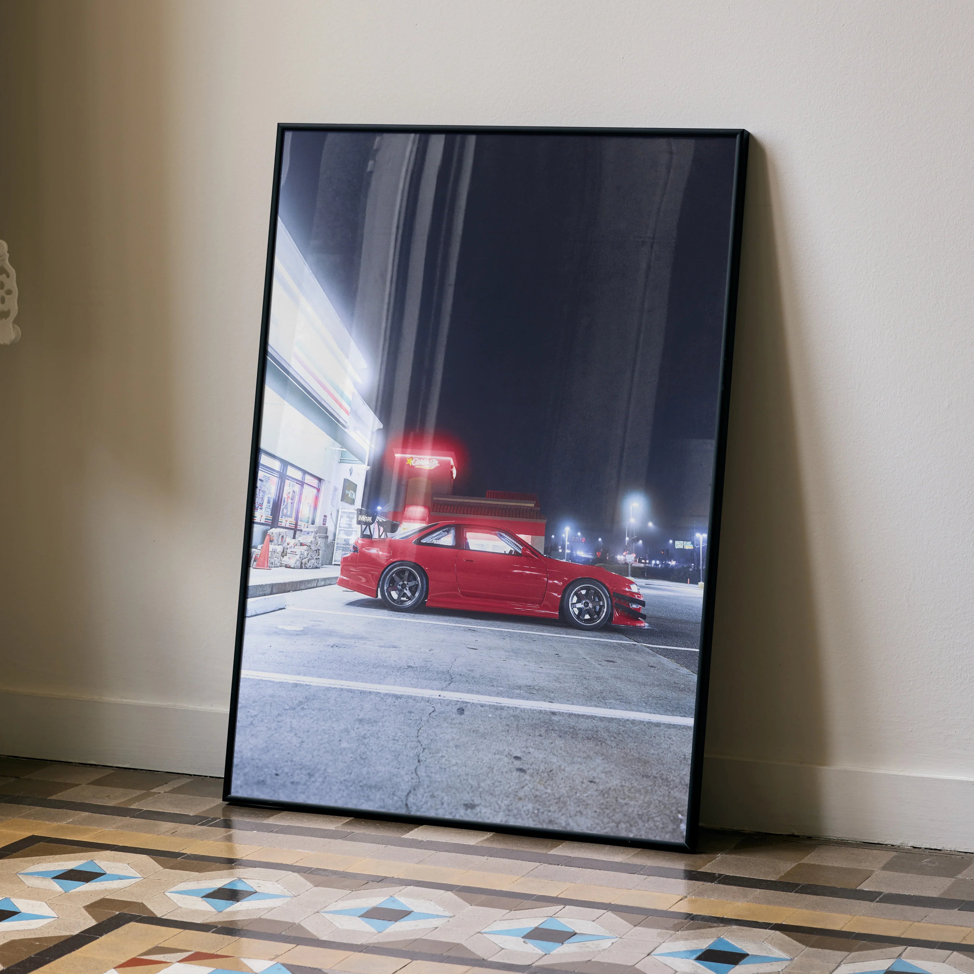 Red Nissan 240sx S14 Kouki poster wall art with night city gas station background in black frame.