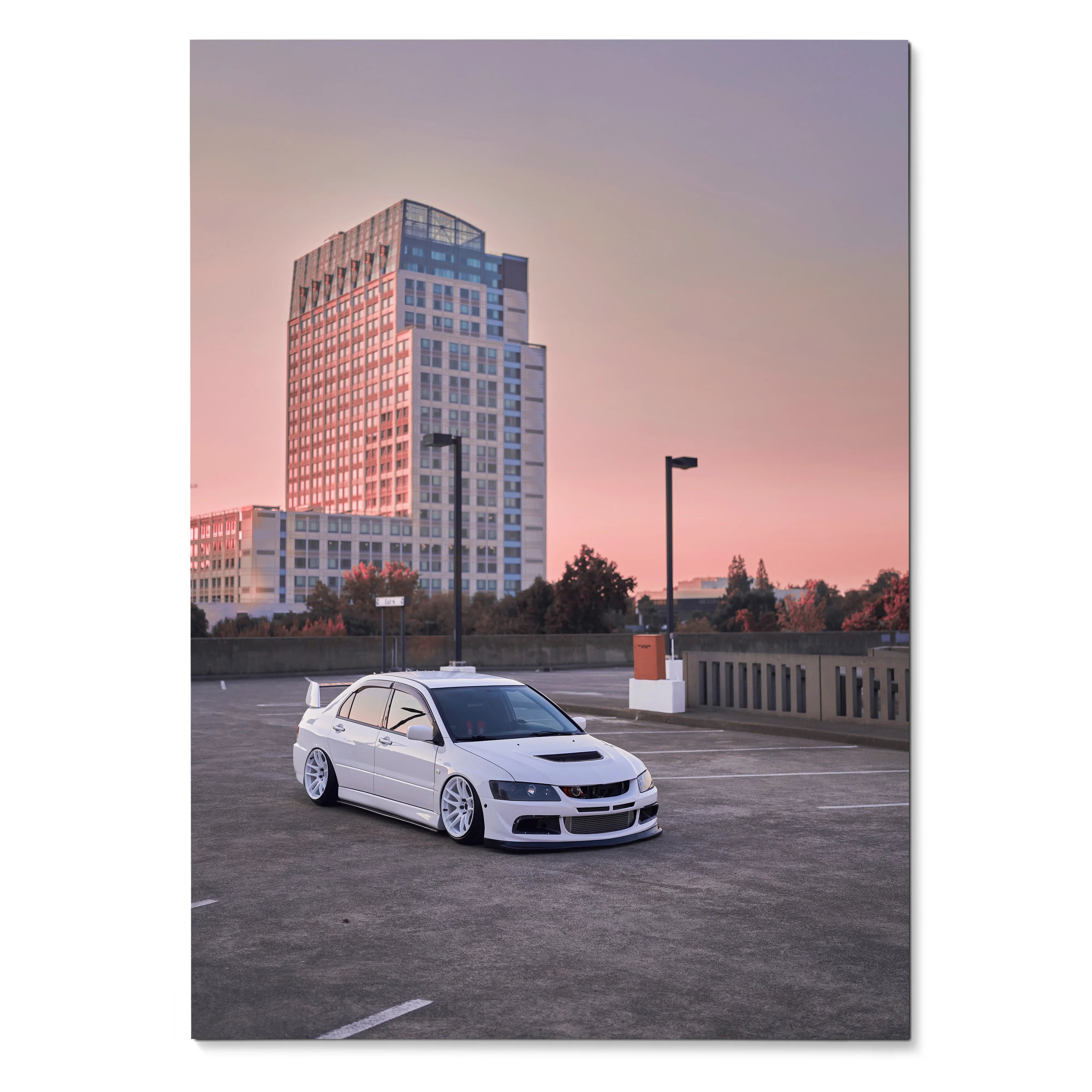 Mitsubishi Evo 8 white car parked on rooftop with city skyline at sunset poster wall art.