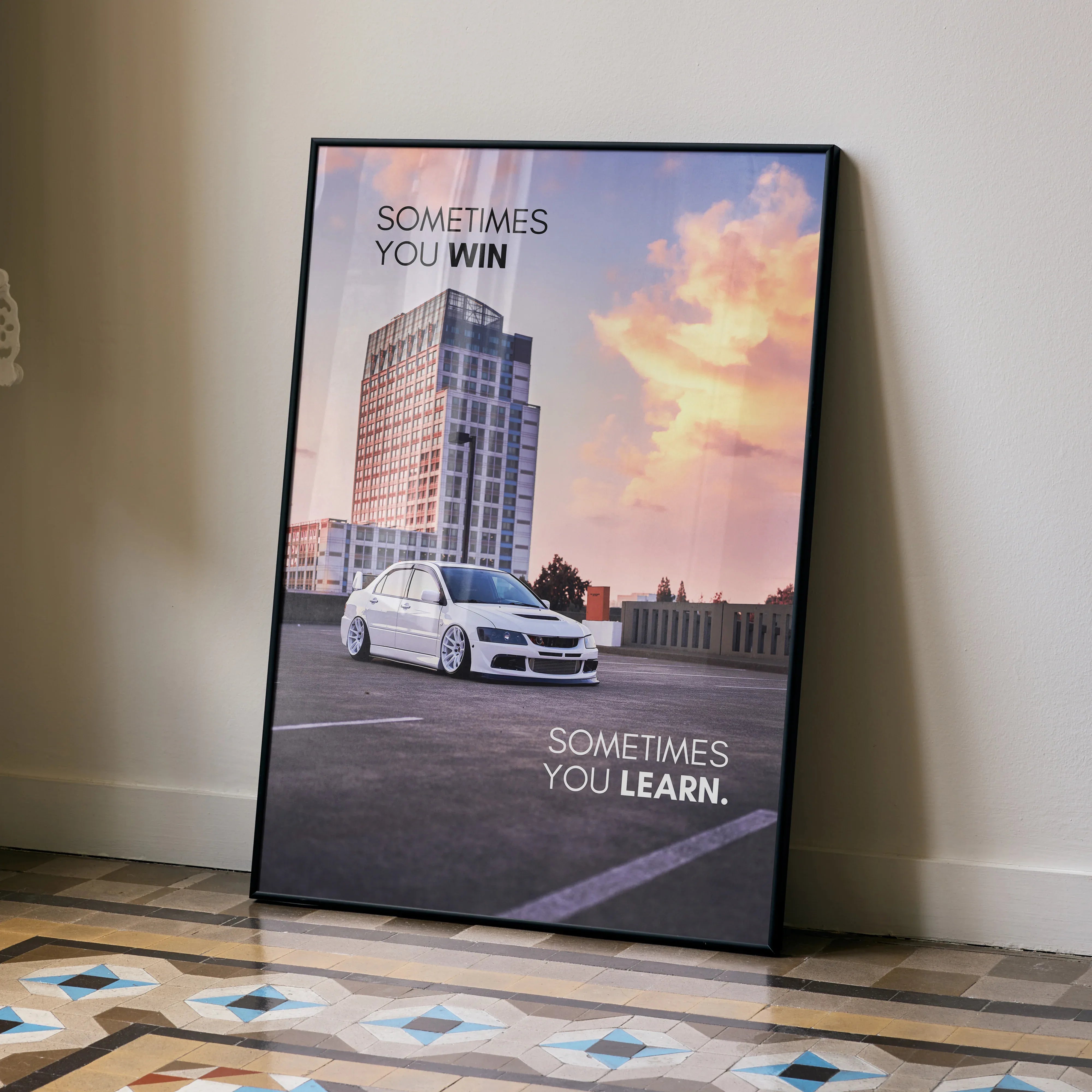 Motivational wall art poster featuring a white Mitsubishi Evo 8 car with inspiring text against a sunset sky background.