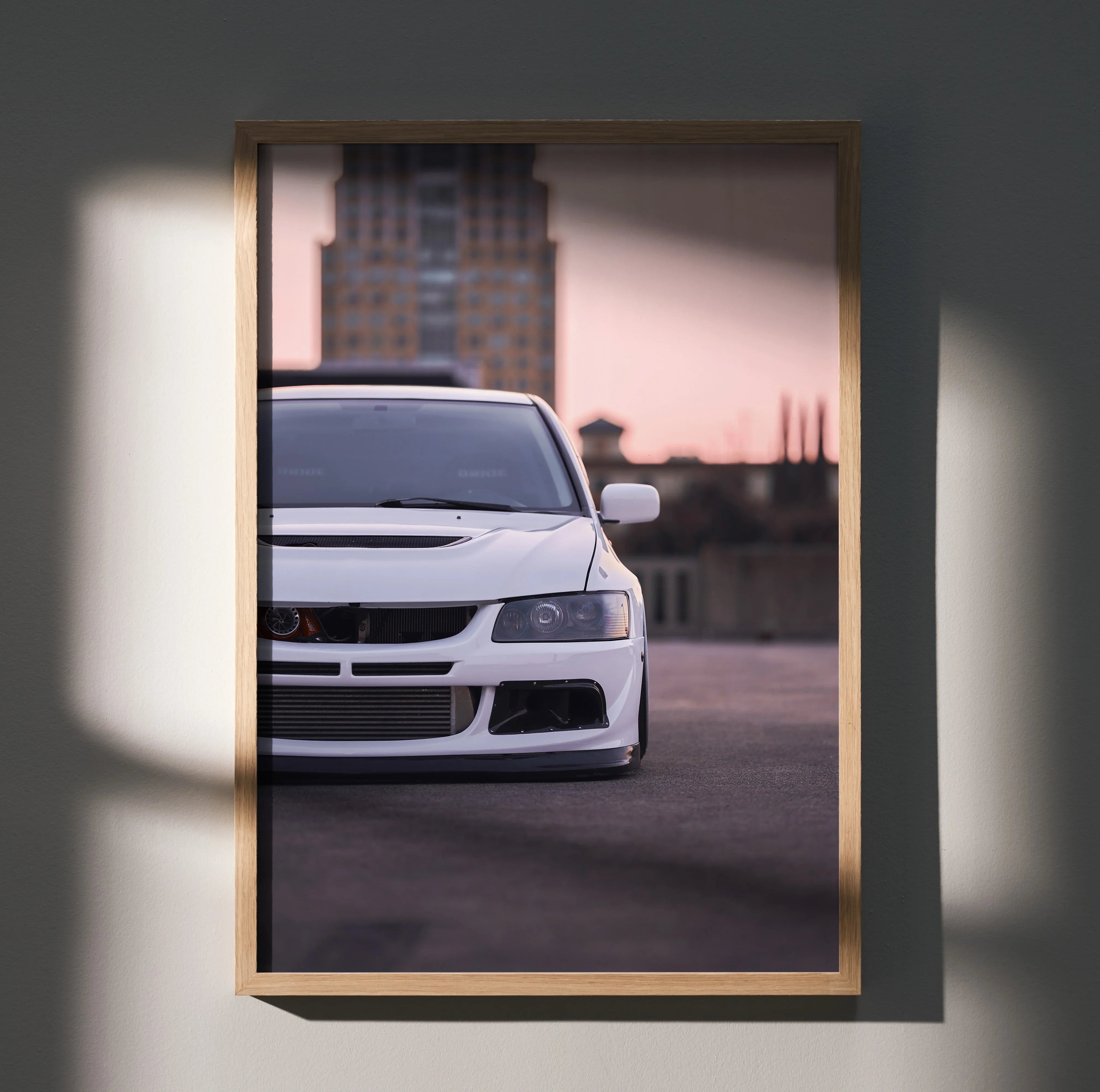 Mitsubishi Evo 8 white car close-up poster framed wall art with city backdrop at dusk.