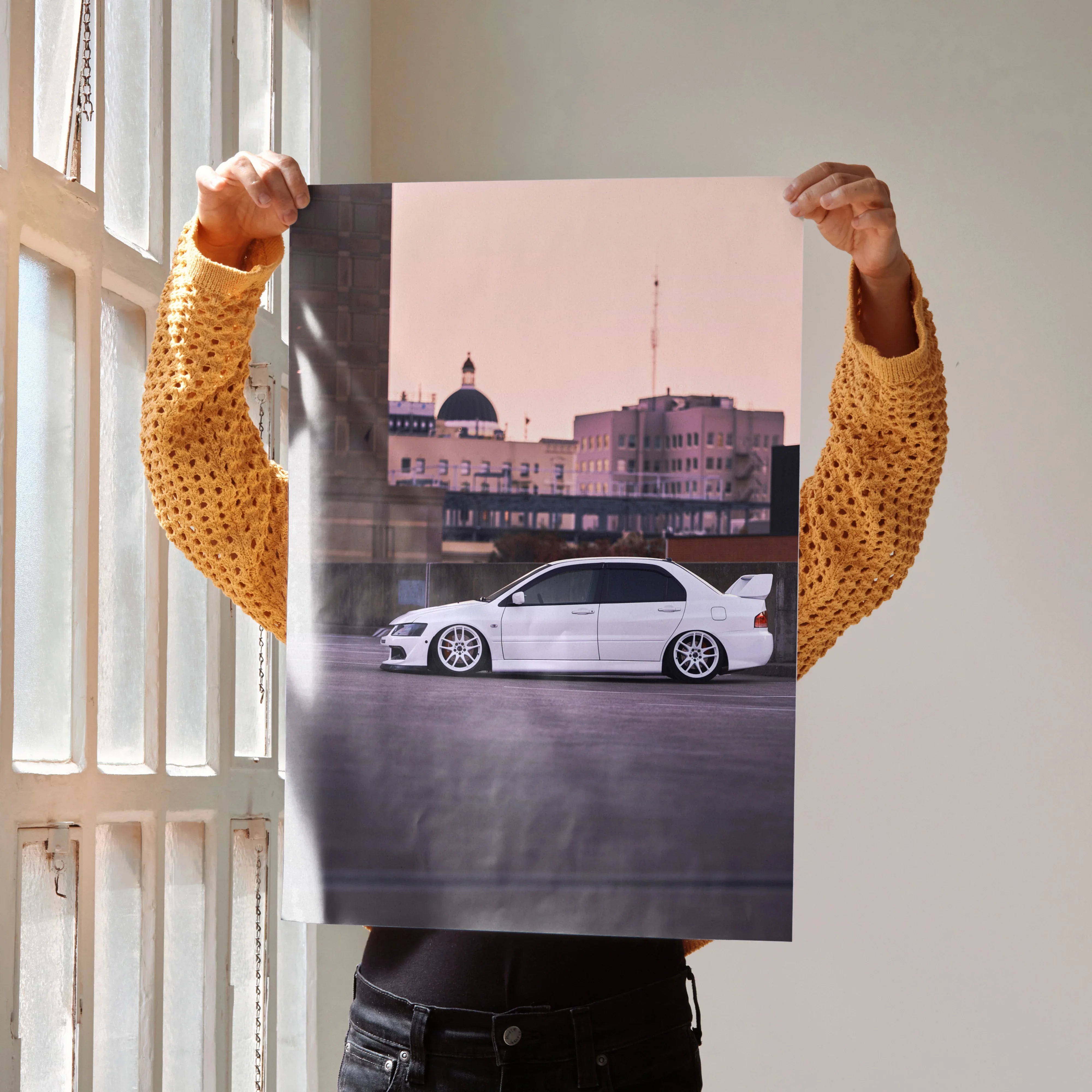 Mitsubishi Evo 8 white car poster with city skyline wall art in soft pink sky background.