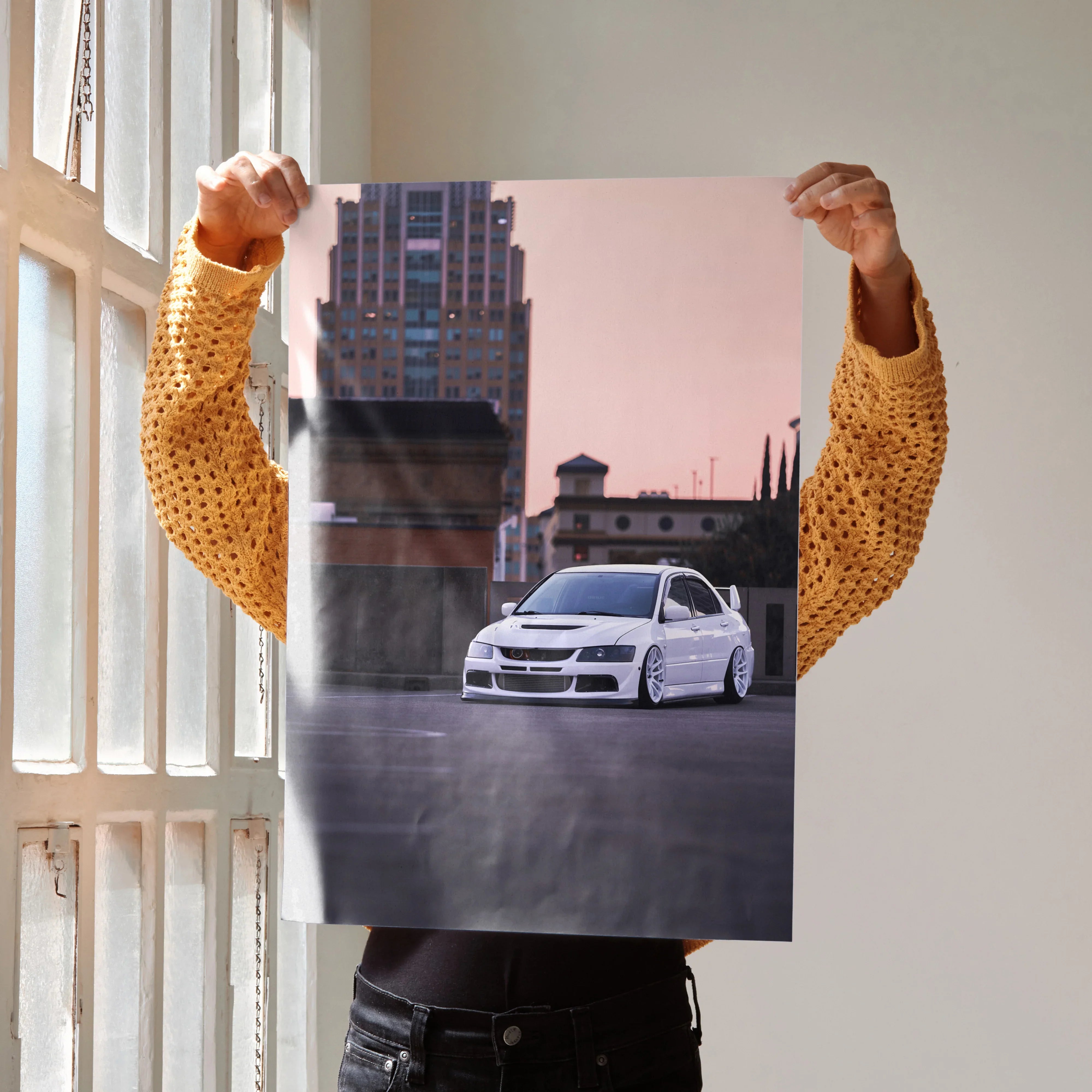 Mitsubishi Evo 8 in white on city street poster wall art with sunset sky background.