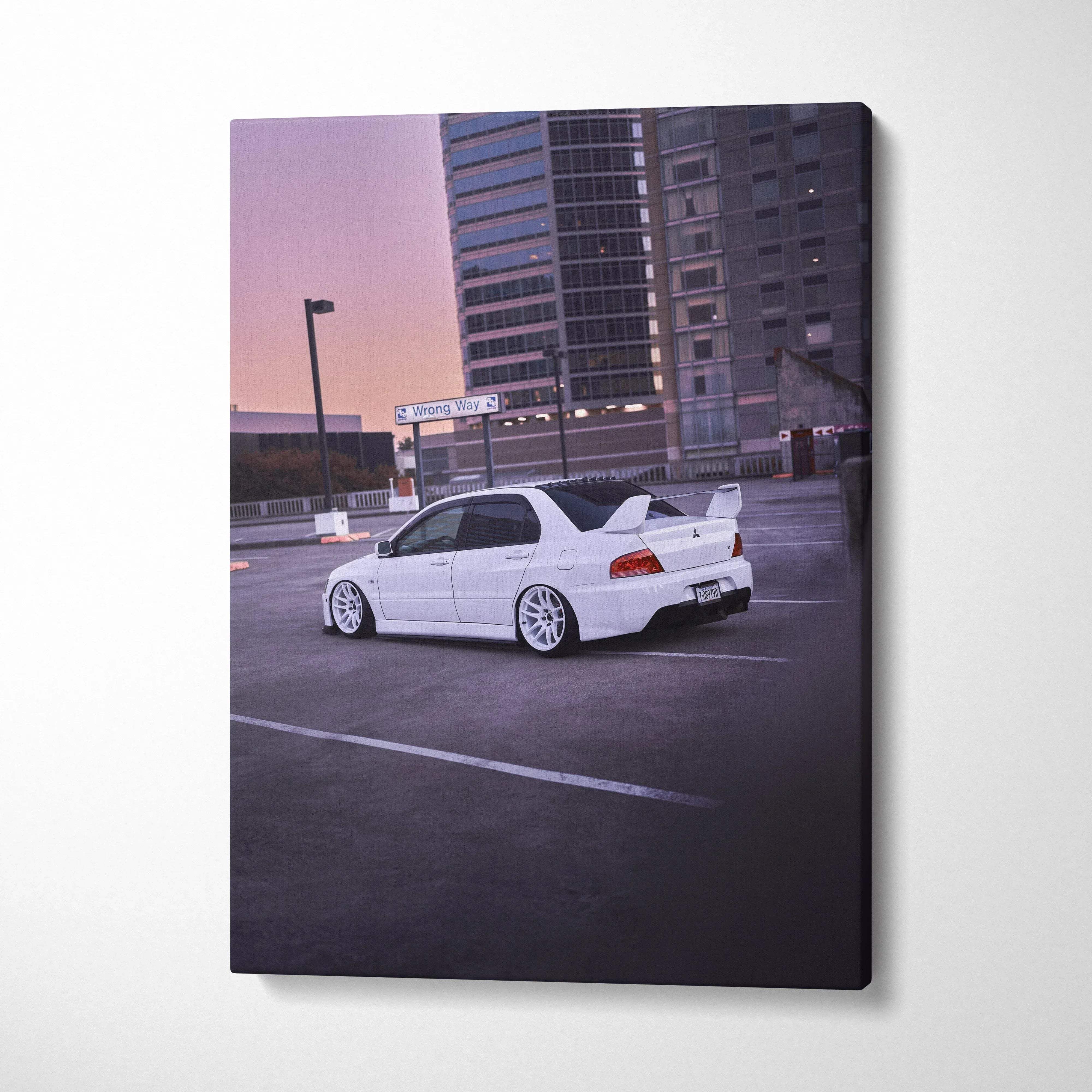 White Mitsubishi Evo 8 parked in urban lot at sunset vertical canvas wall art.