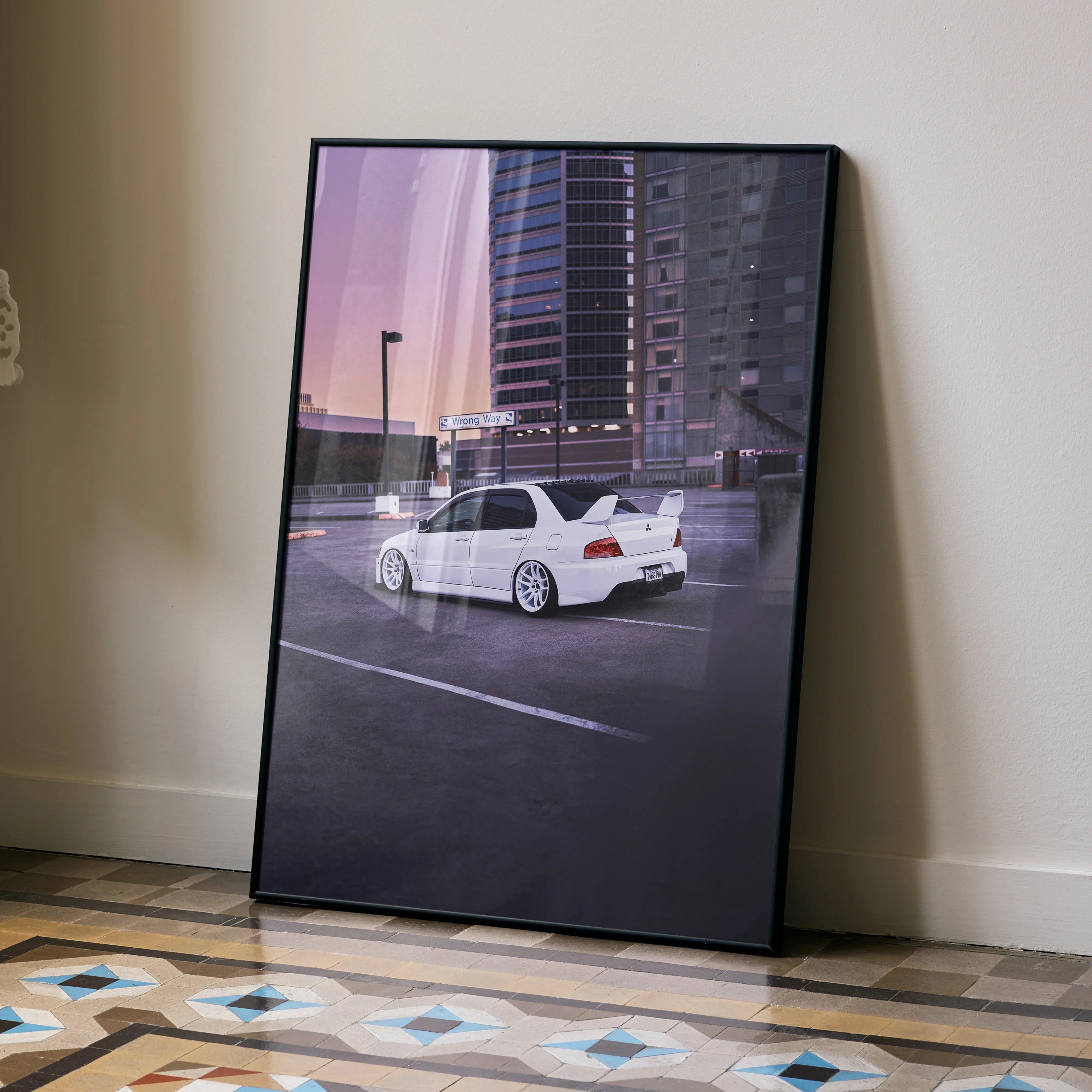 Mitsubishi Evo 8 poster showing white car parked in urban lot at sunset, modern wall art with cityscape background.