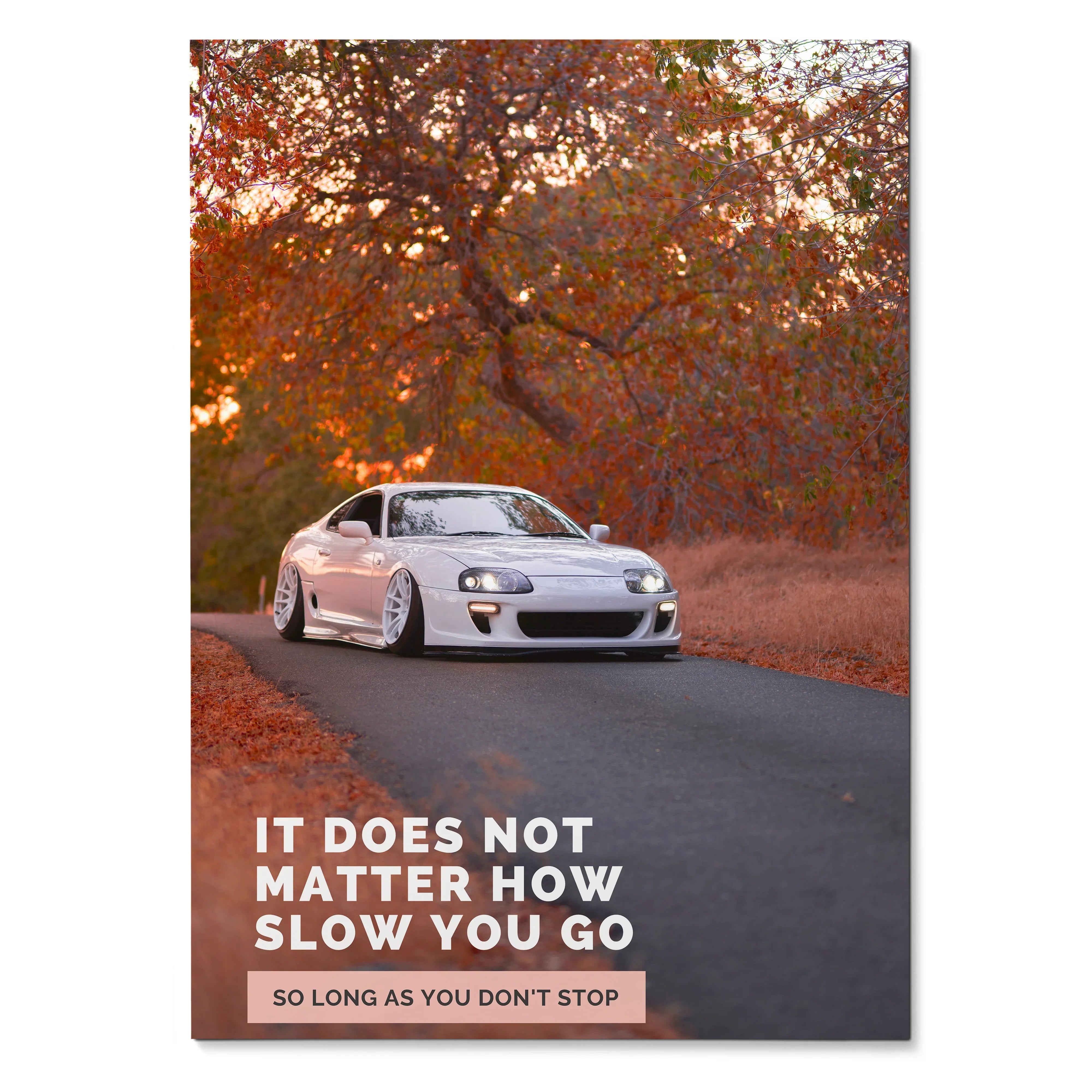 White Toyota Supra Mk4 on winding road with autumn trees and motivational text poster wall art.