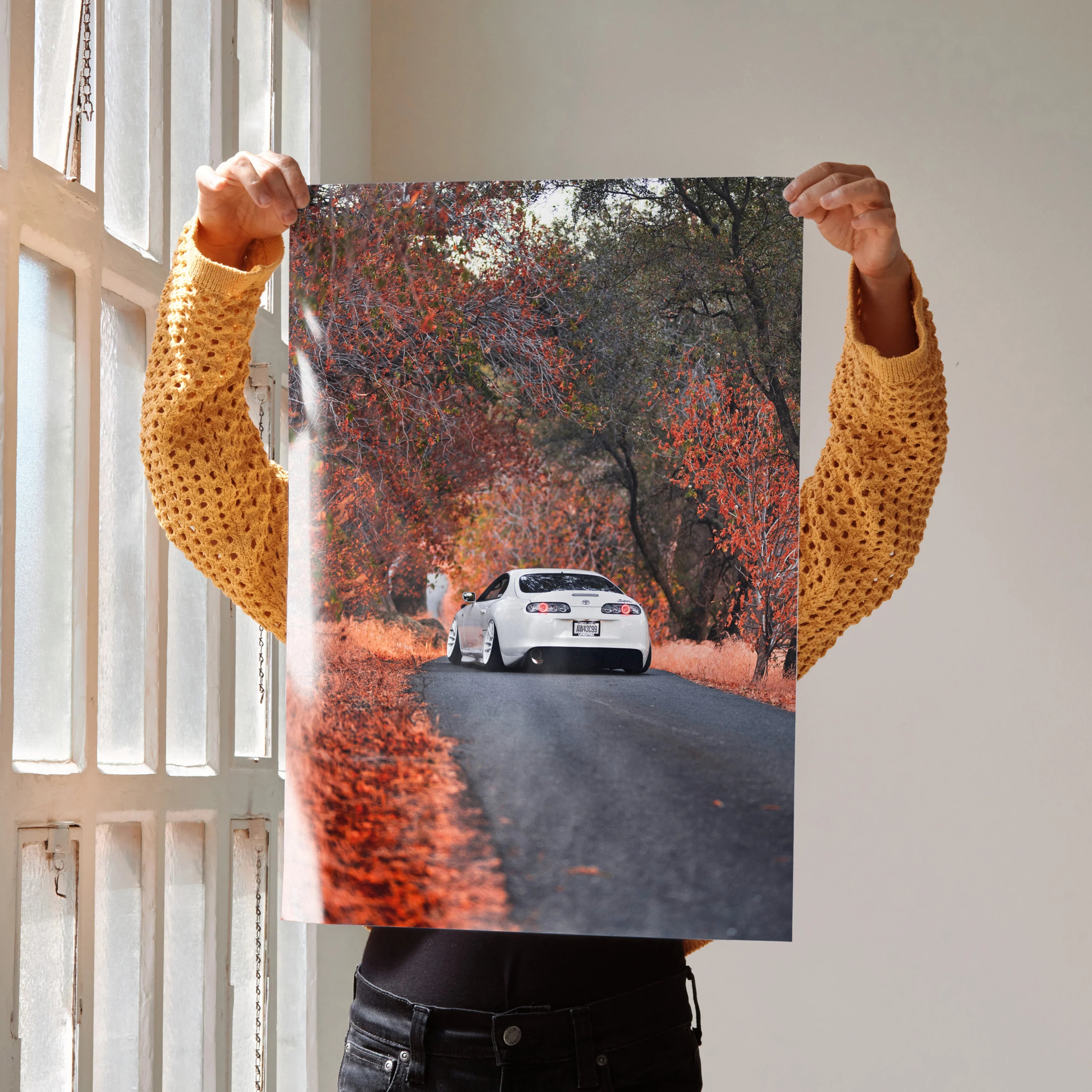 Toyota Supra MK4 racing down autumn road poster wall art with vivid fall foliage.