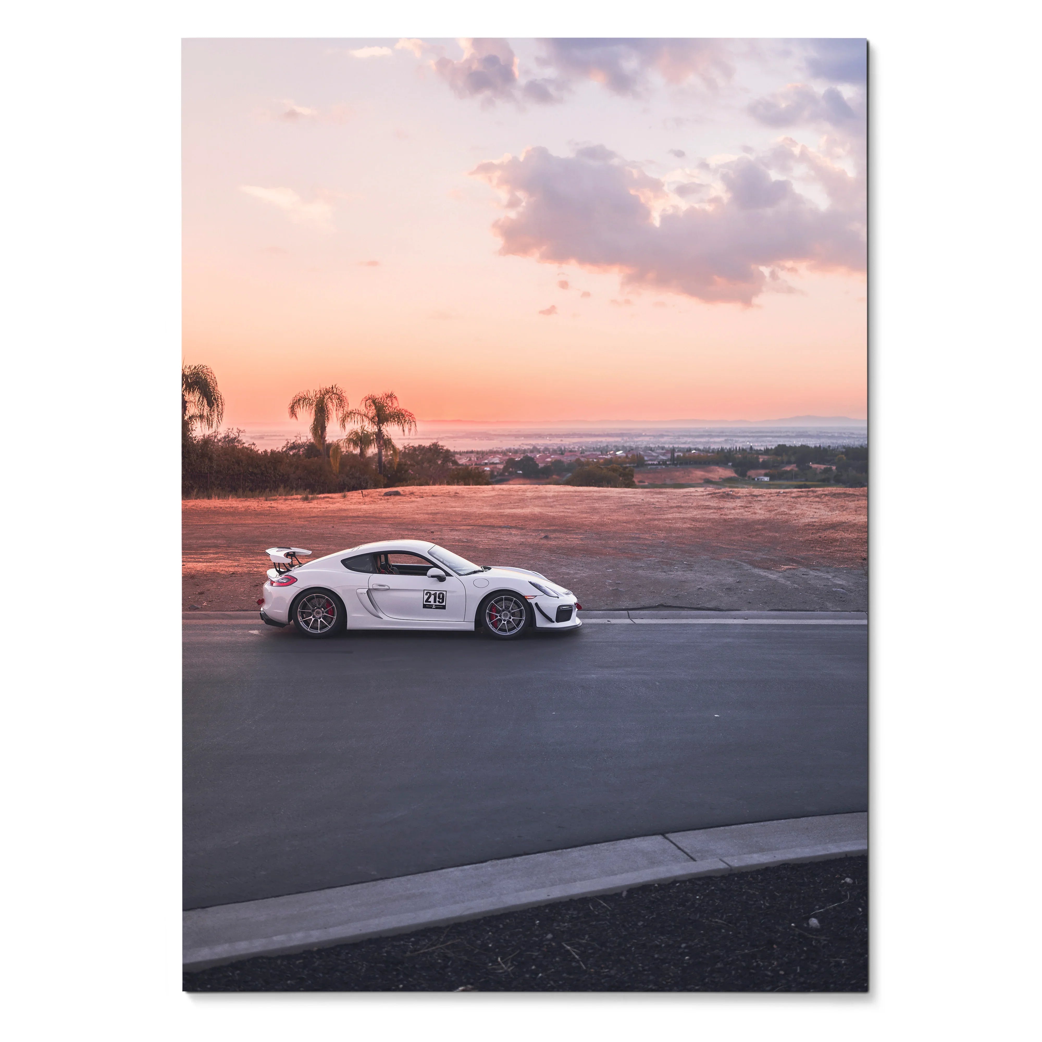 Porsche GT4 sports car driving at sunset with palm trees in background poster wall art.
