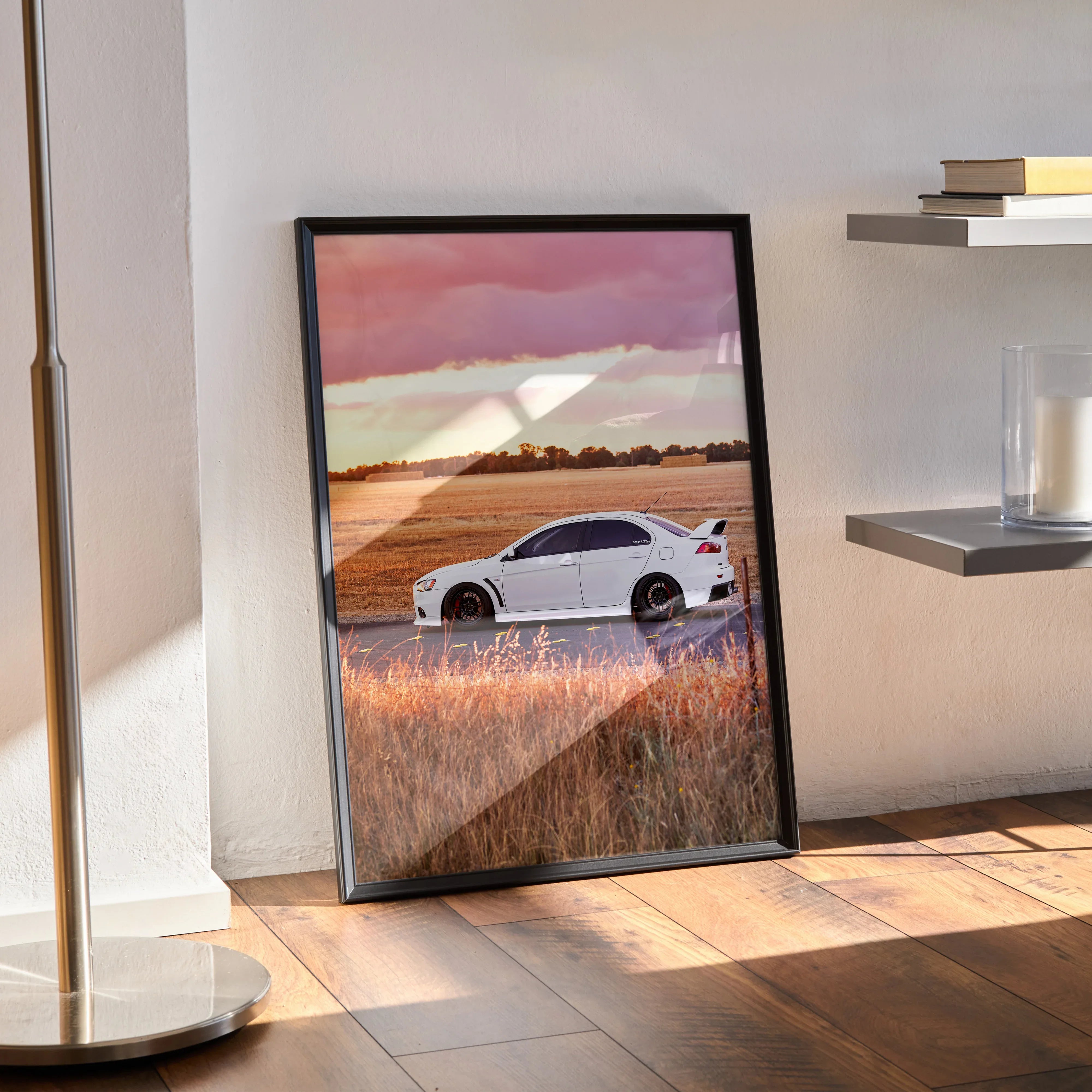 Mitsubishi Evo 10 white car poster with sunset sky, displayed as wall art in black frame.
