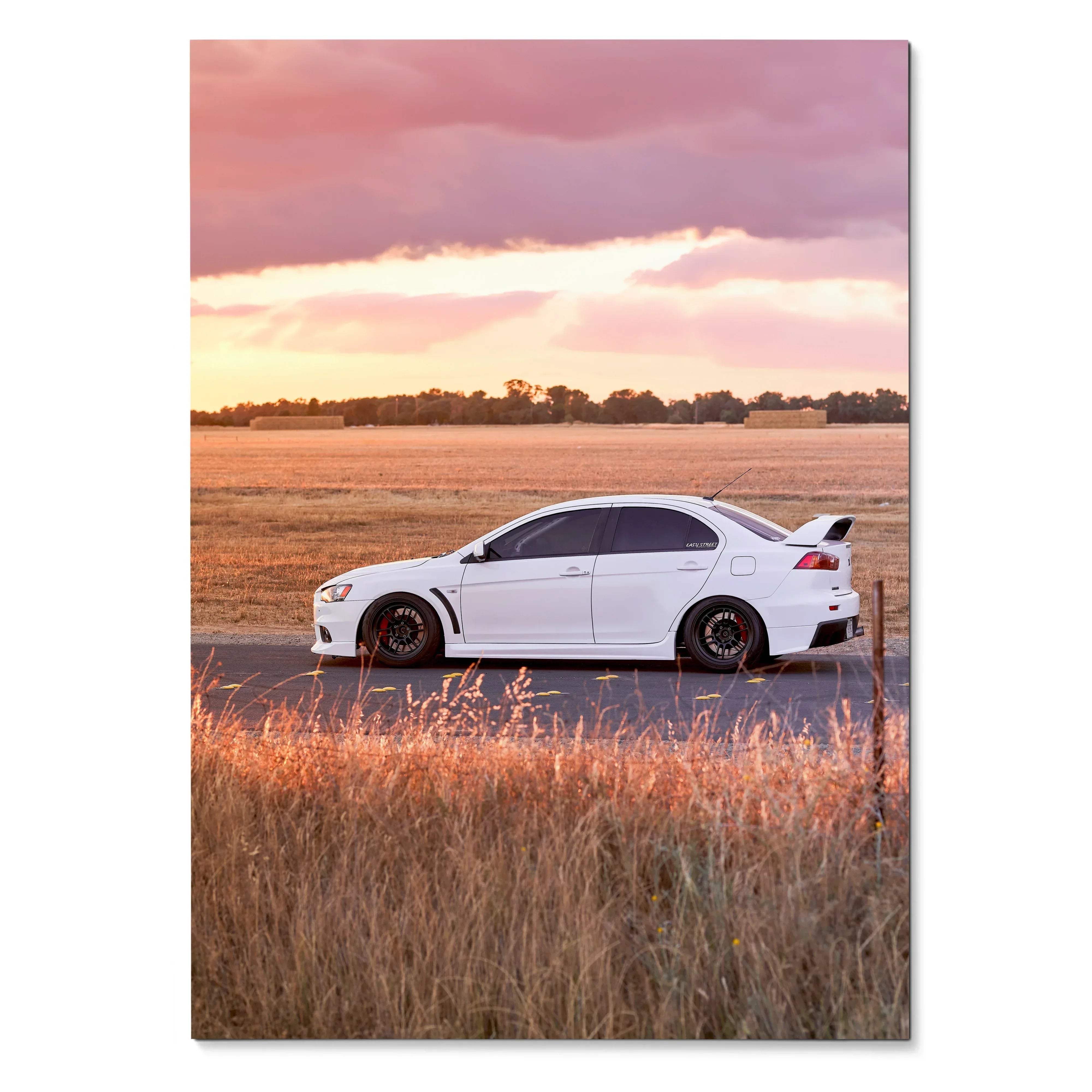 Mitsubishi Evo 10 parked on road at sunset in high-resolution poster wall art.