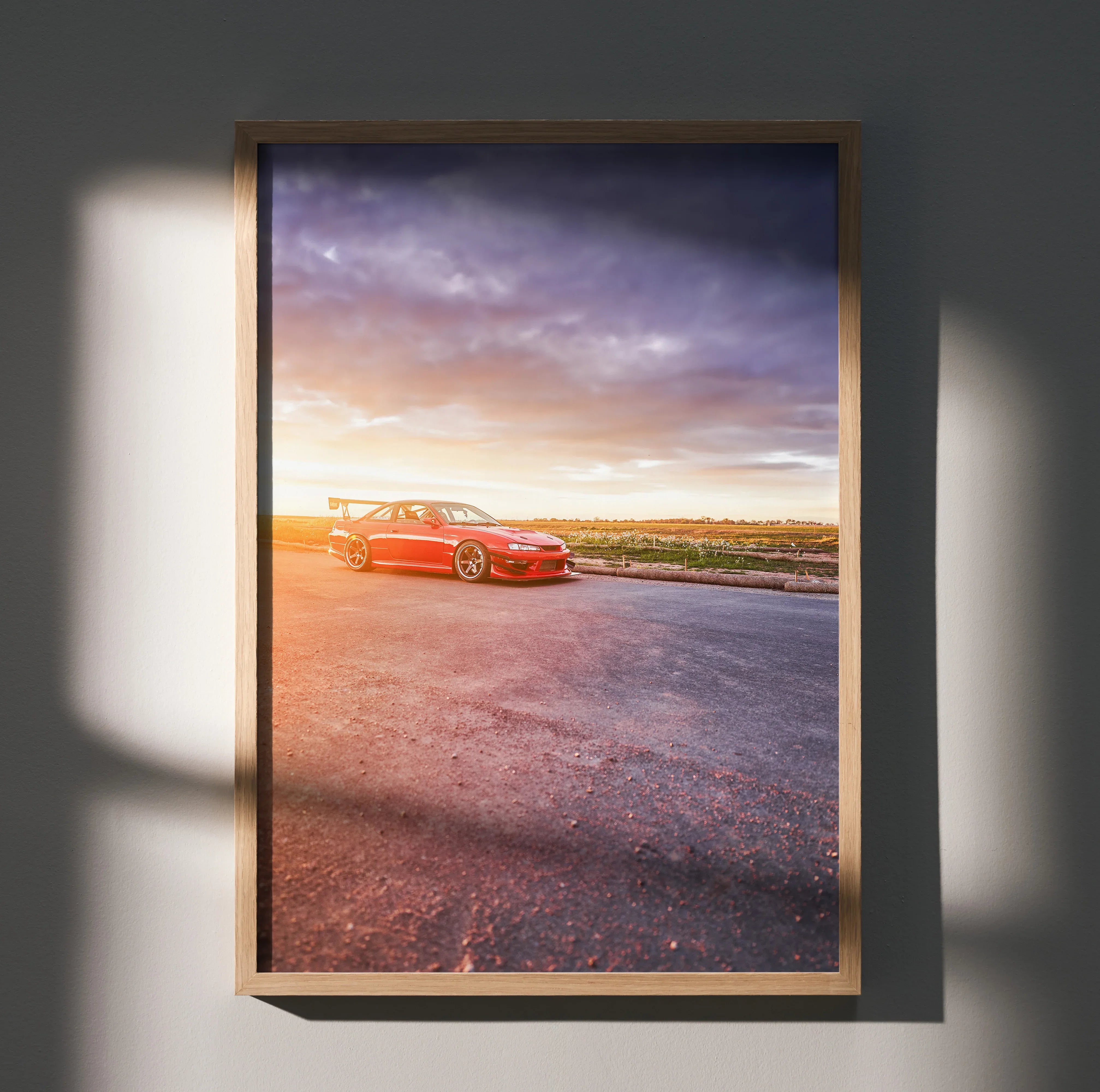 Nissan 240sx S14 Kouki in red parked on road at sunset poster wall art in wooden frame.