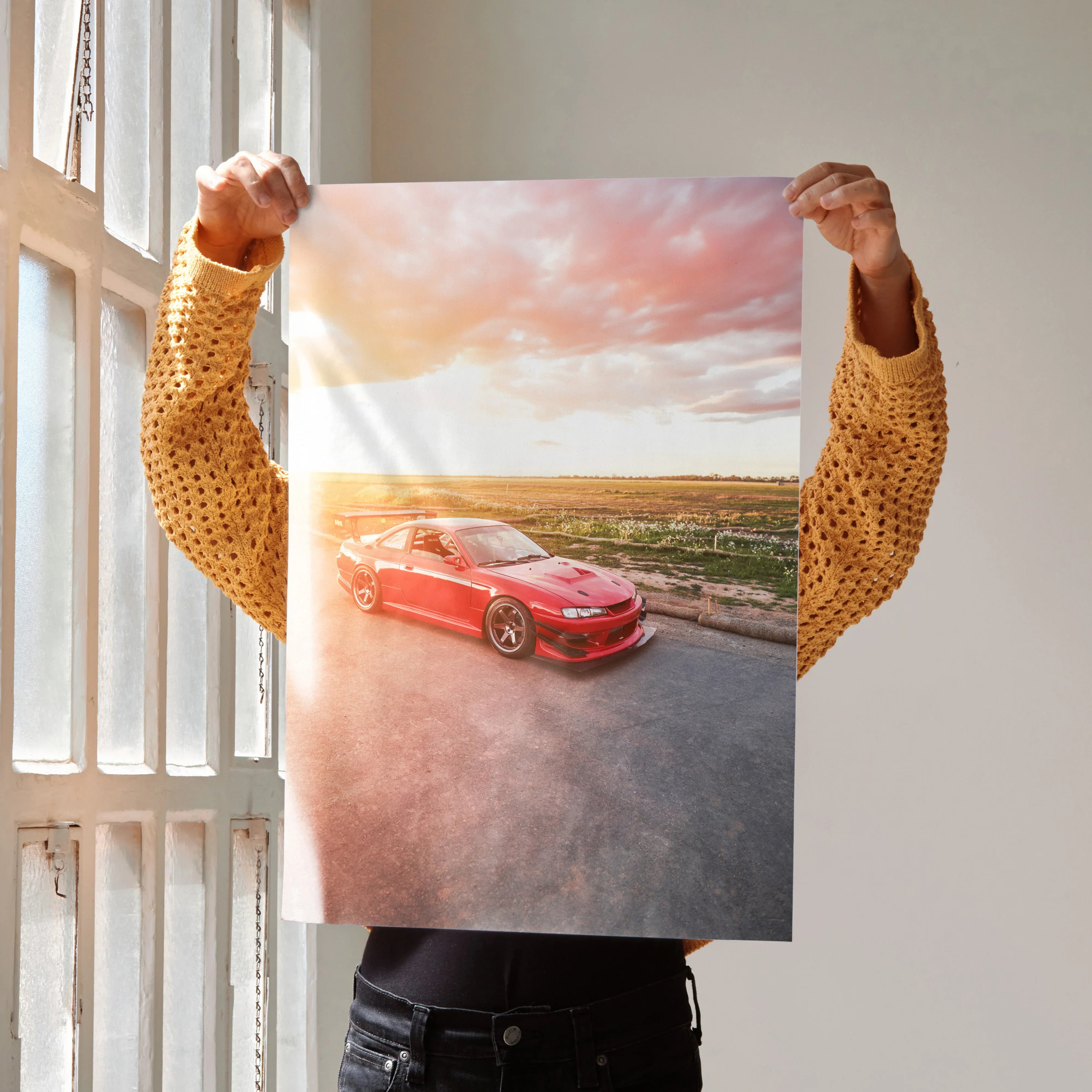 Poster of red Nissan 240sx S14 Kouki on road at sunset wall art with vibrant sky colors.