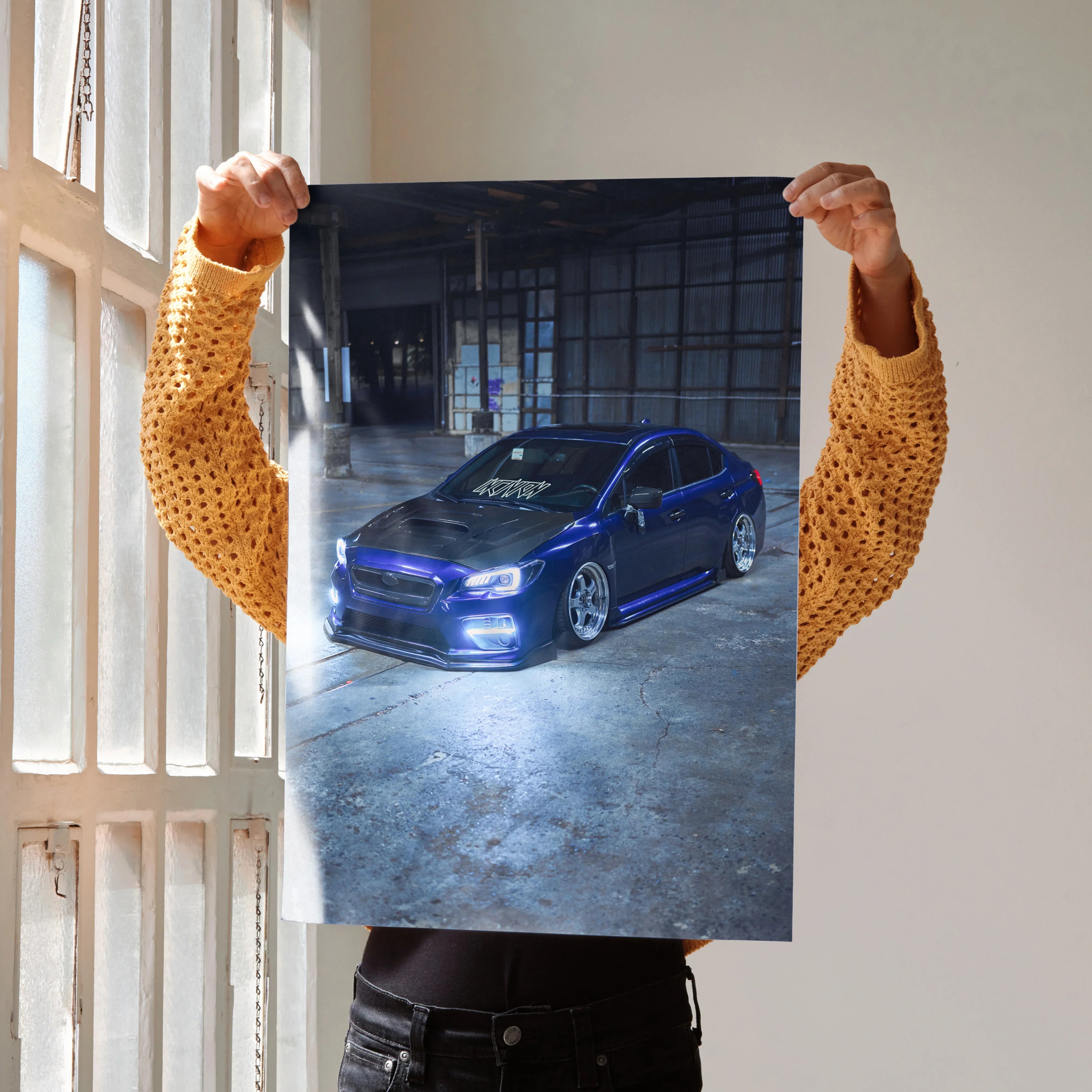 Subaru WRX poster wall art featuring a blue car in a dim industrial setting.