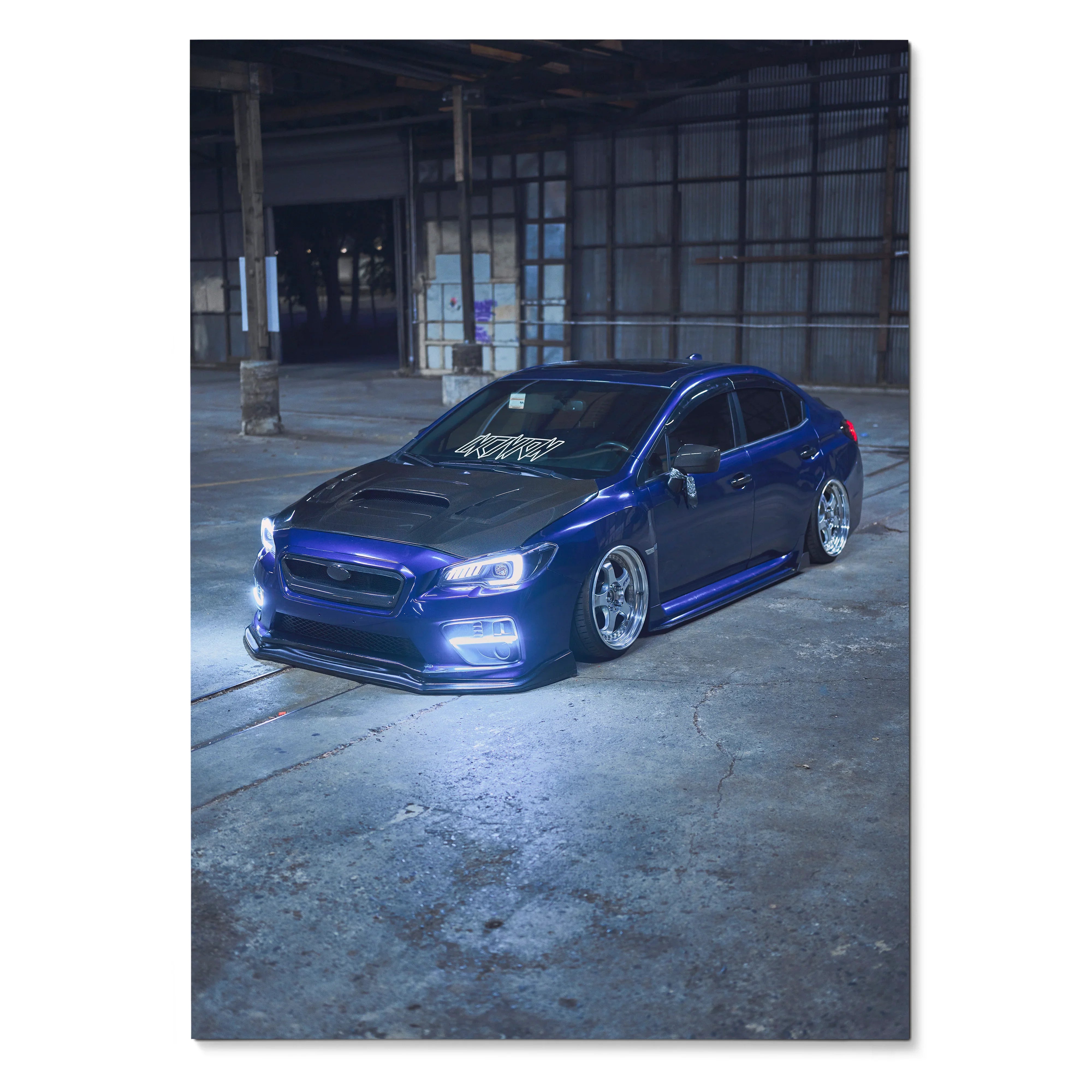 Blue Subaru WRX parked in an industrial space, automotive poster wall art with moody lighting.