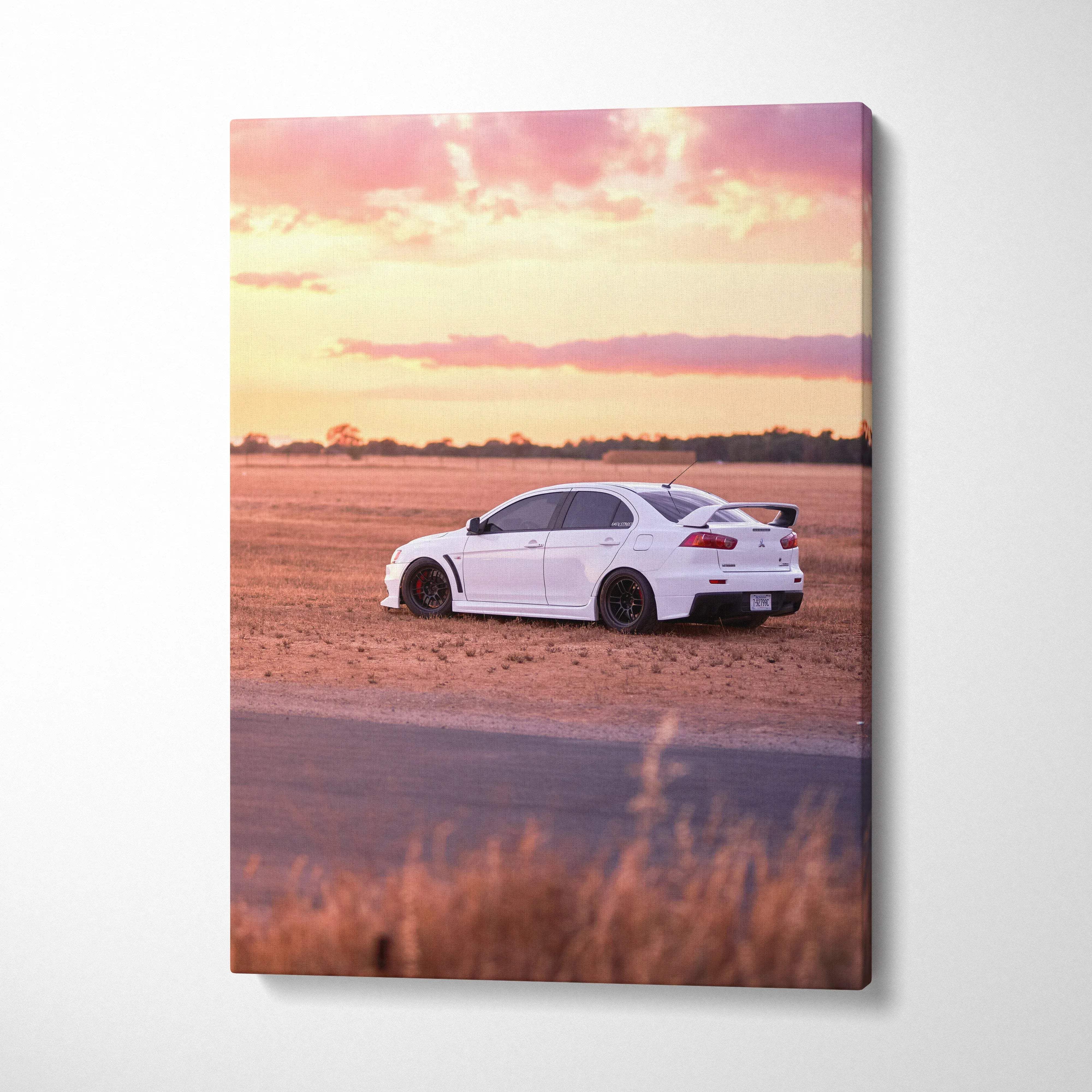 White Mitsubishi Evo 10 on dirt road at sunset vertical canvas wall art.