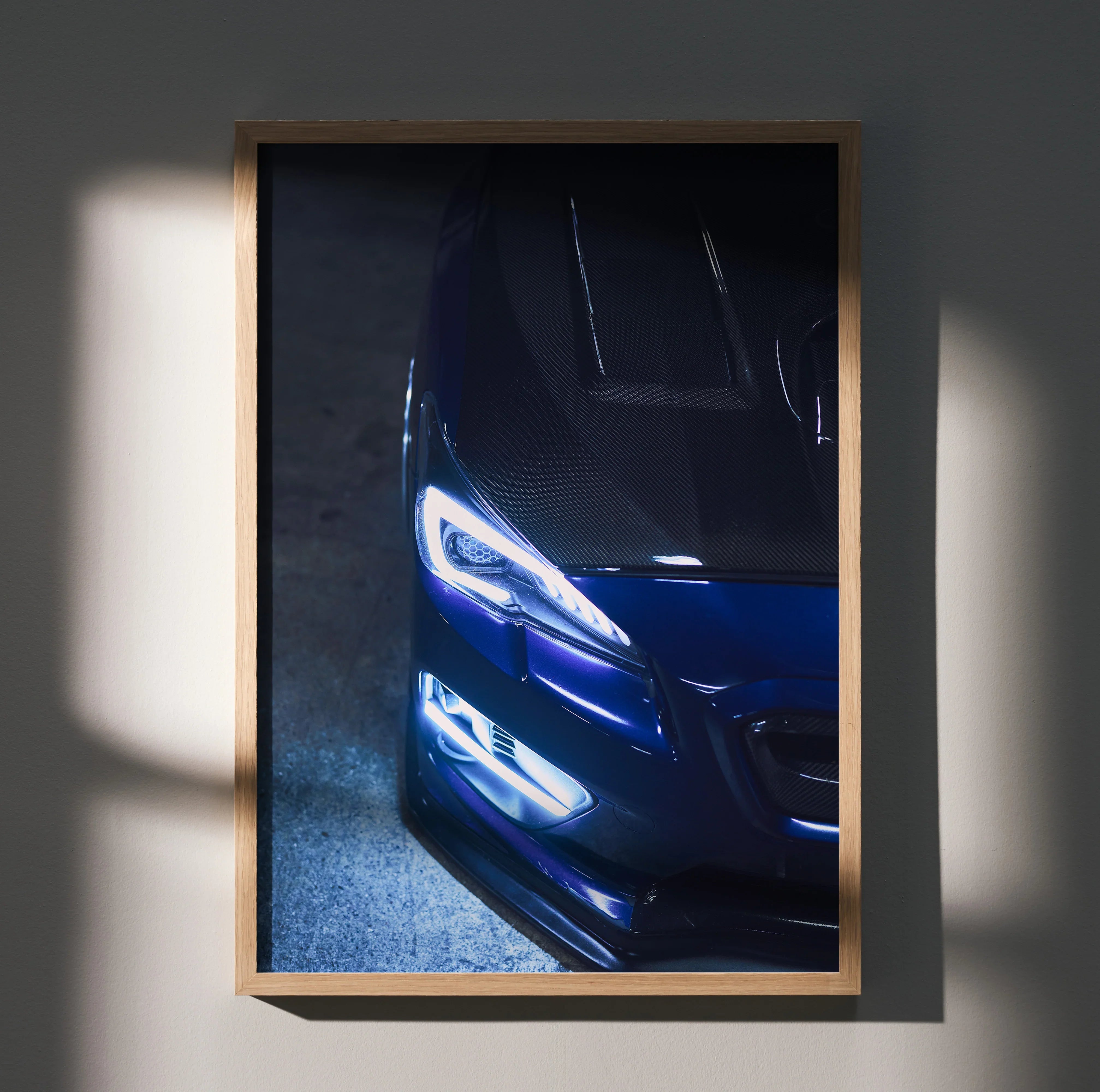 Subaru WRX close-up poster with illuminated headlights, premium automotive wall art in wooden frame.