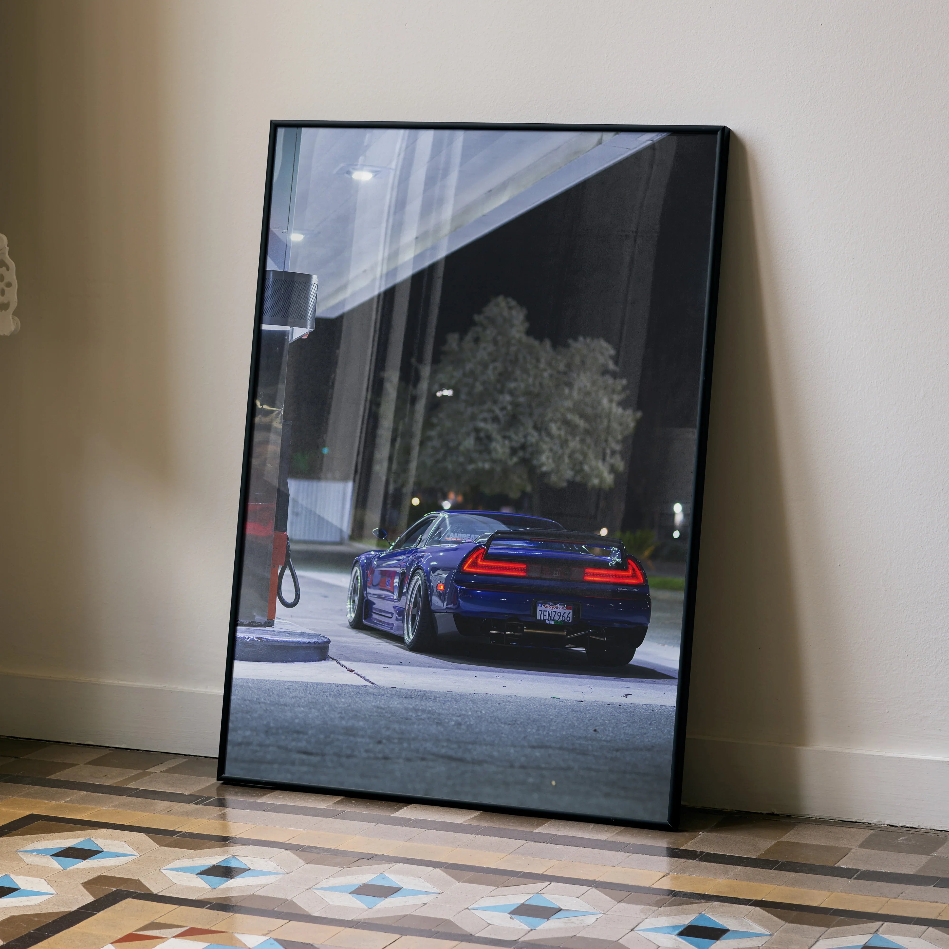 Acura NSX night scene poster leaning against wall, high-resolution wall art with dark tones and street lighting.