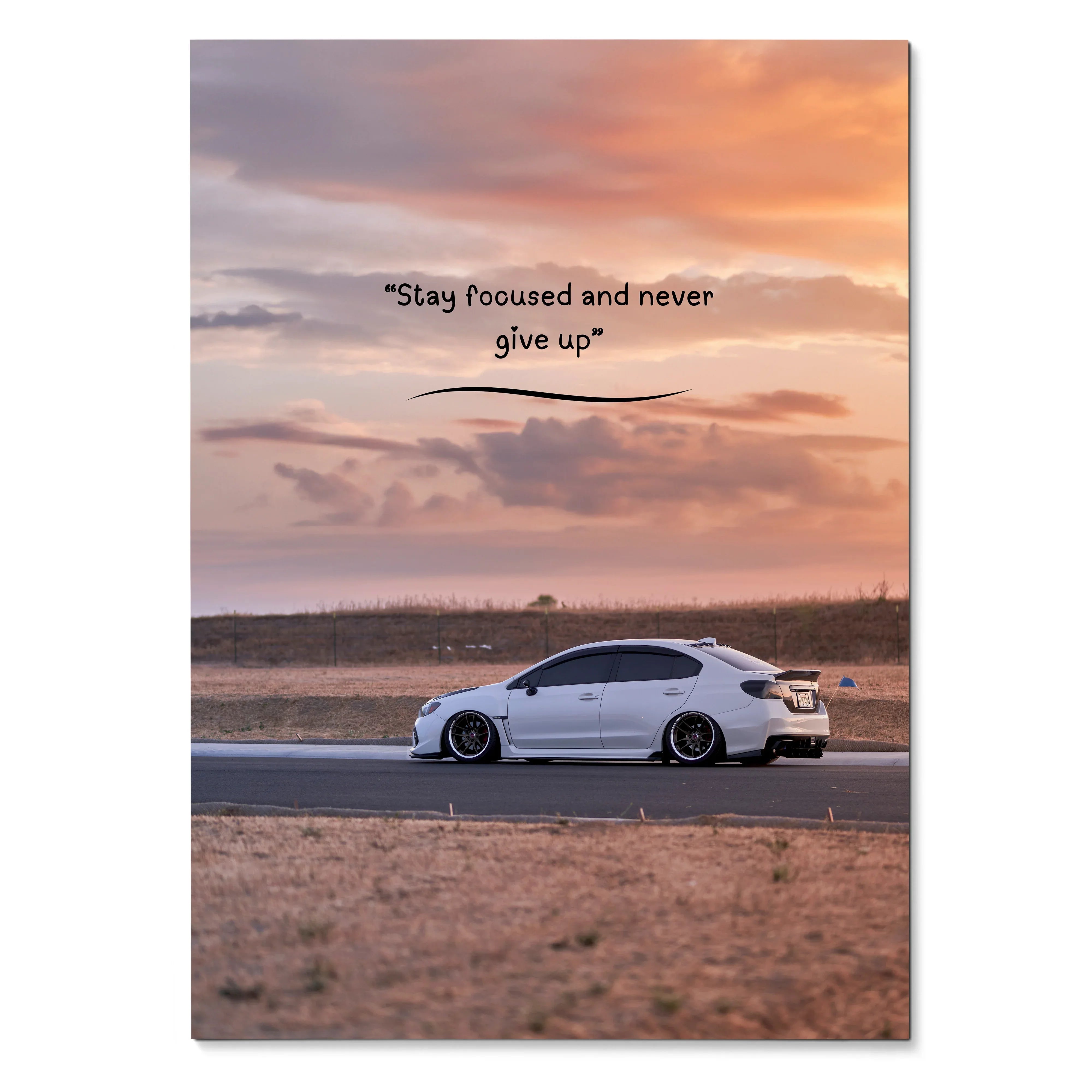 Motivational poster wall art featuring white Subaru WRX on a road at sunset with inspiring text.