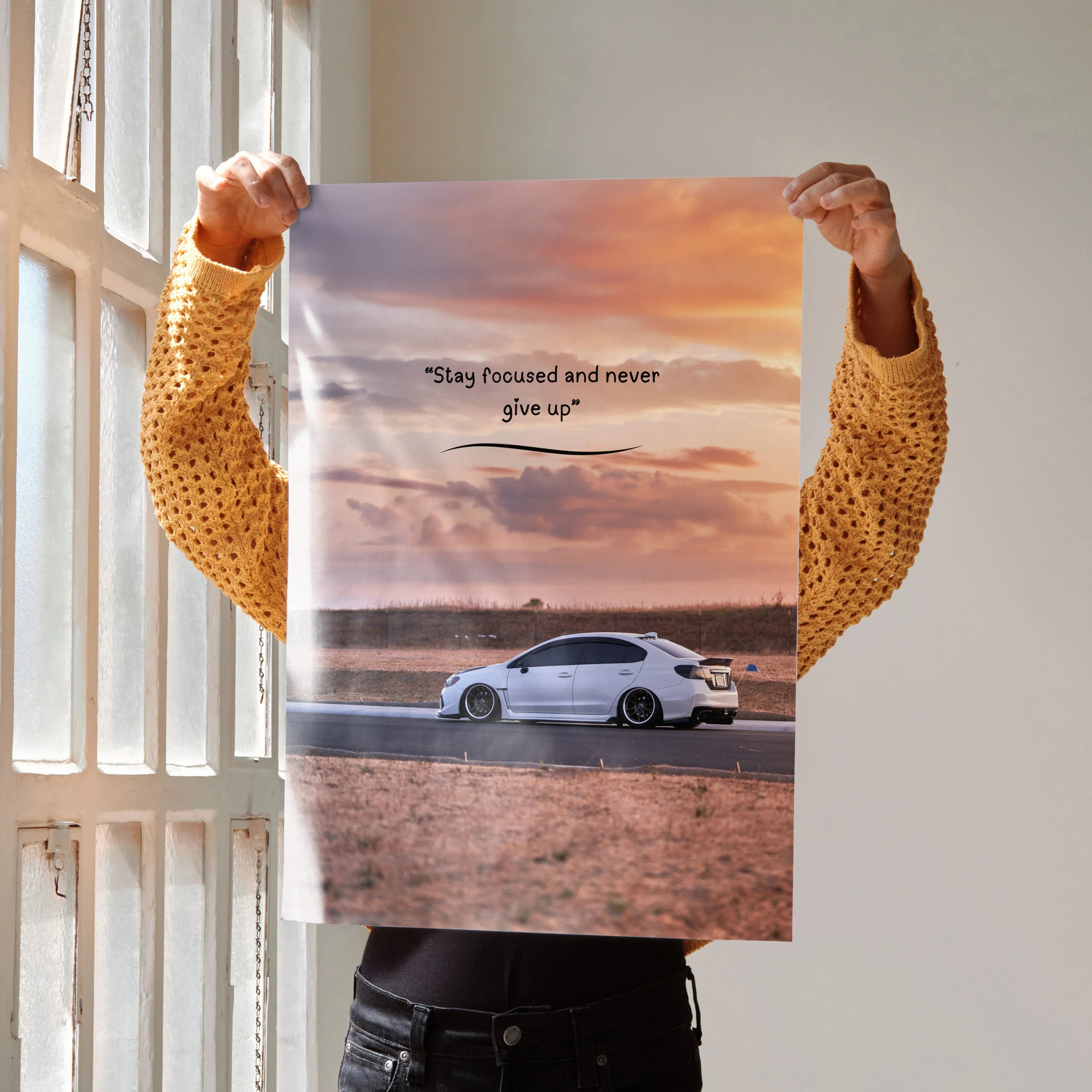 Motivational poster wall art featuring white Subaru WRX with inspiring text and sunset background.