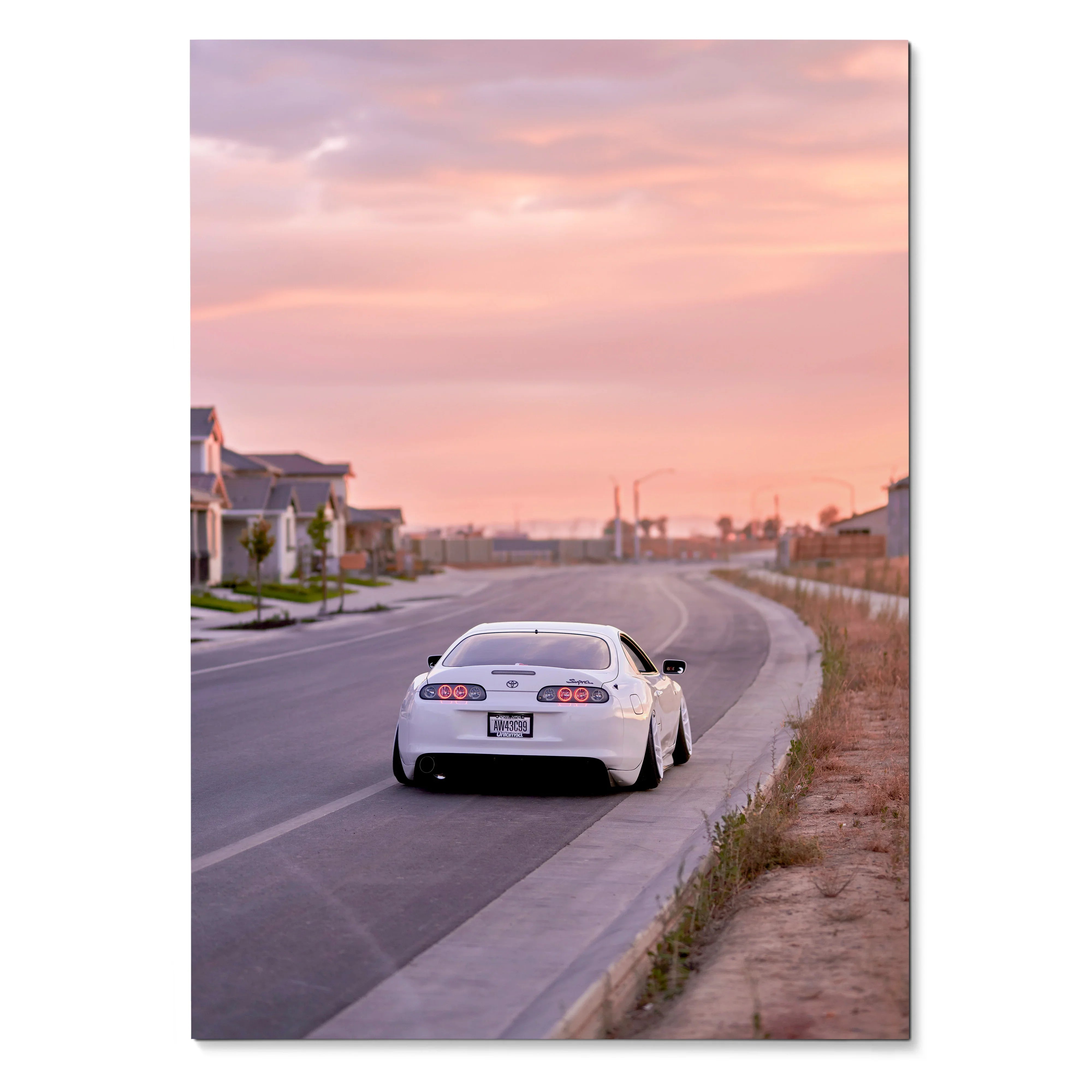 White Toyota Supra MK4 driving on suburban road at pink sunset sky poster wall art.