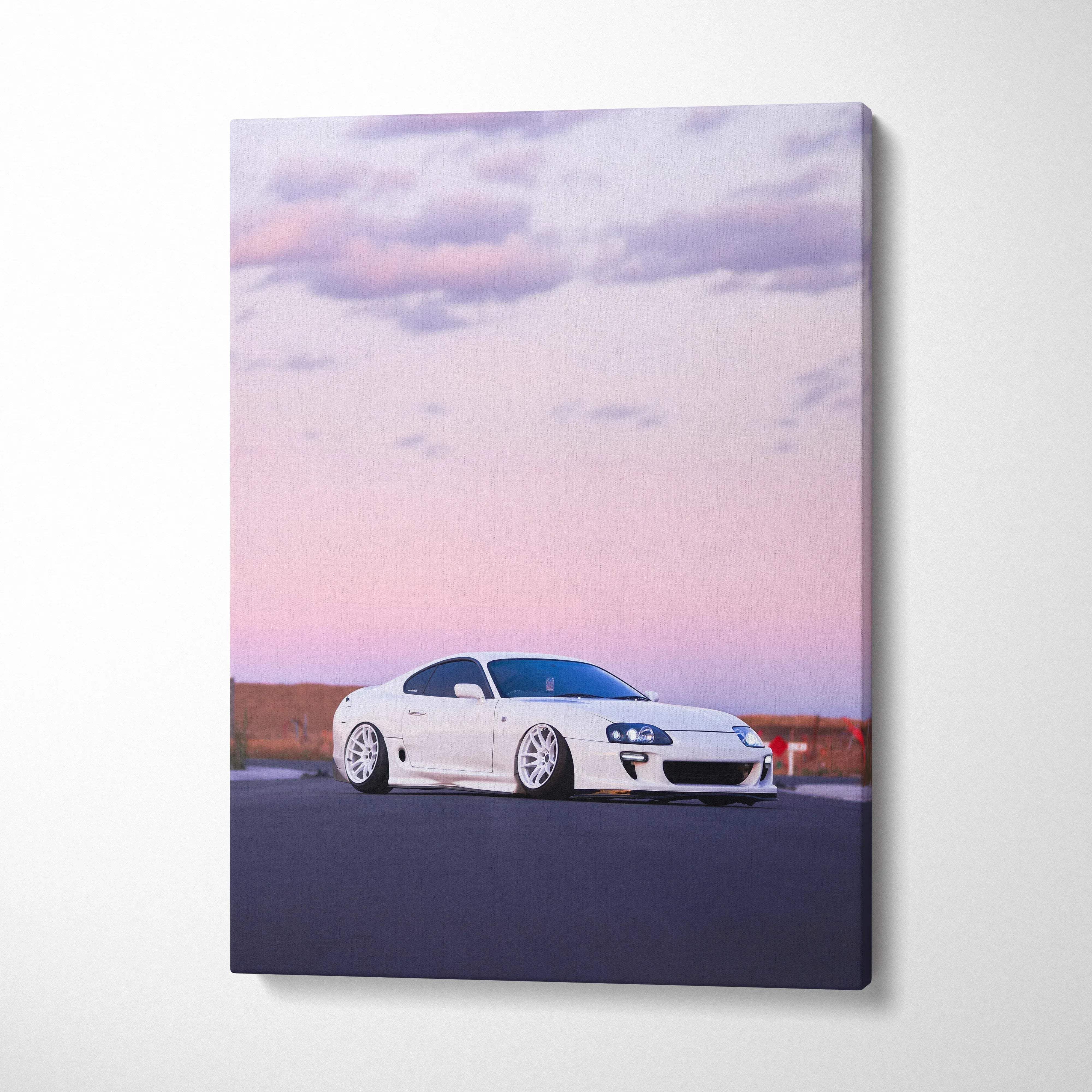 White Toyota Supra MK4 on road at sunset with pink sky, vertical canvas wall art.