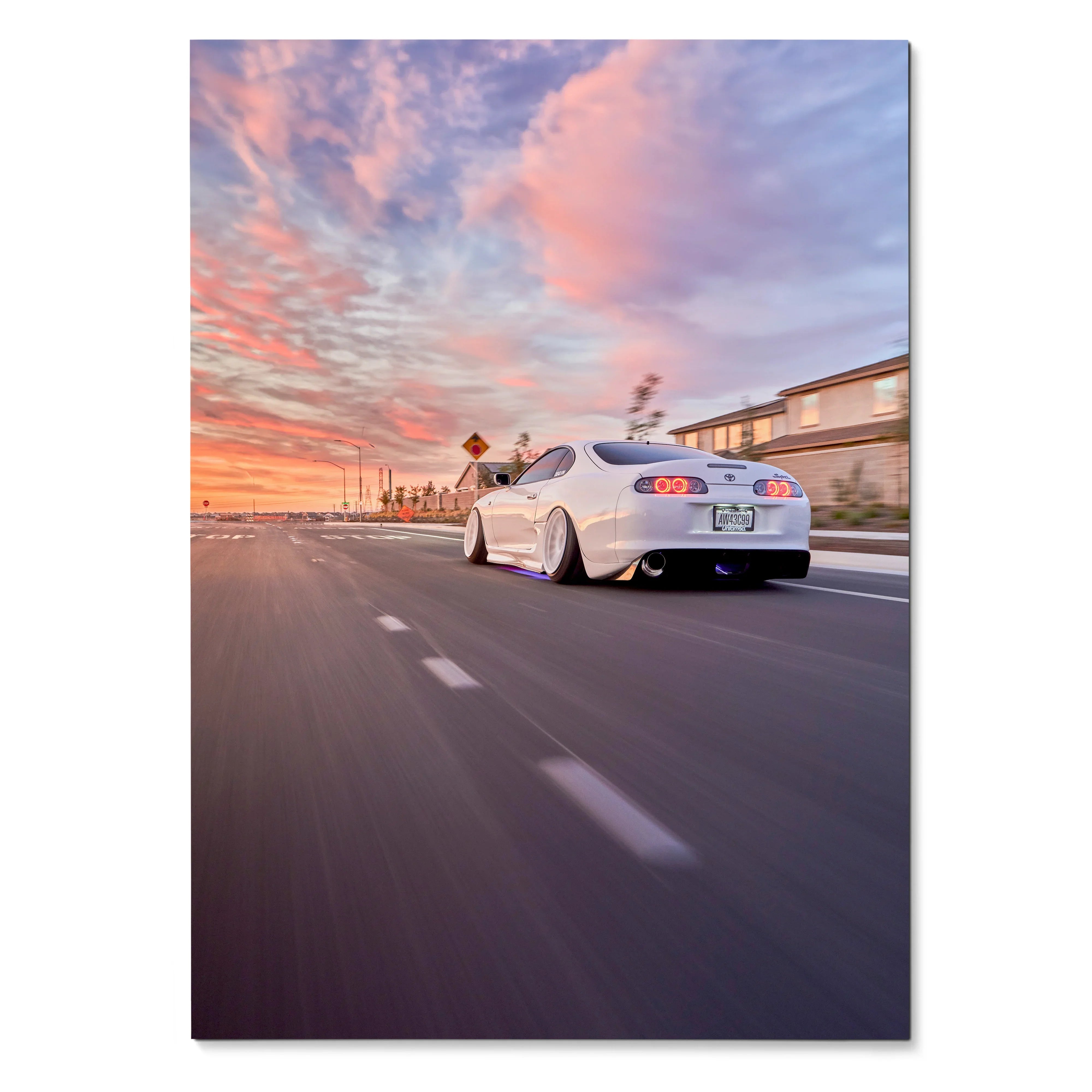 Toyota Supra MK4 driving on road at sunset with vibrant sky poster wall art.