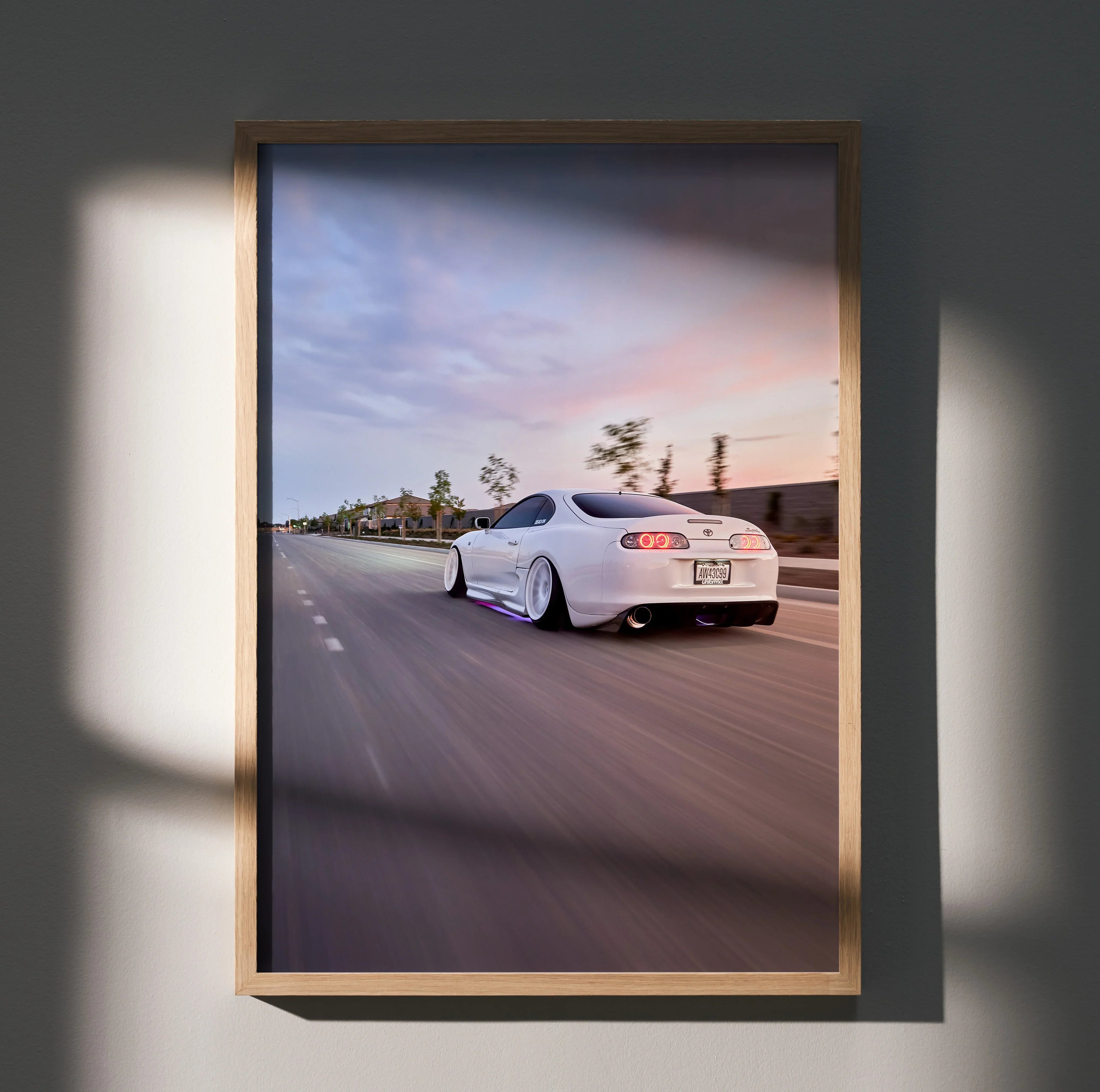 Toyota Supra MK4 in white driving on highway at sunset poster wall art.