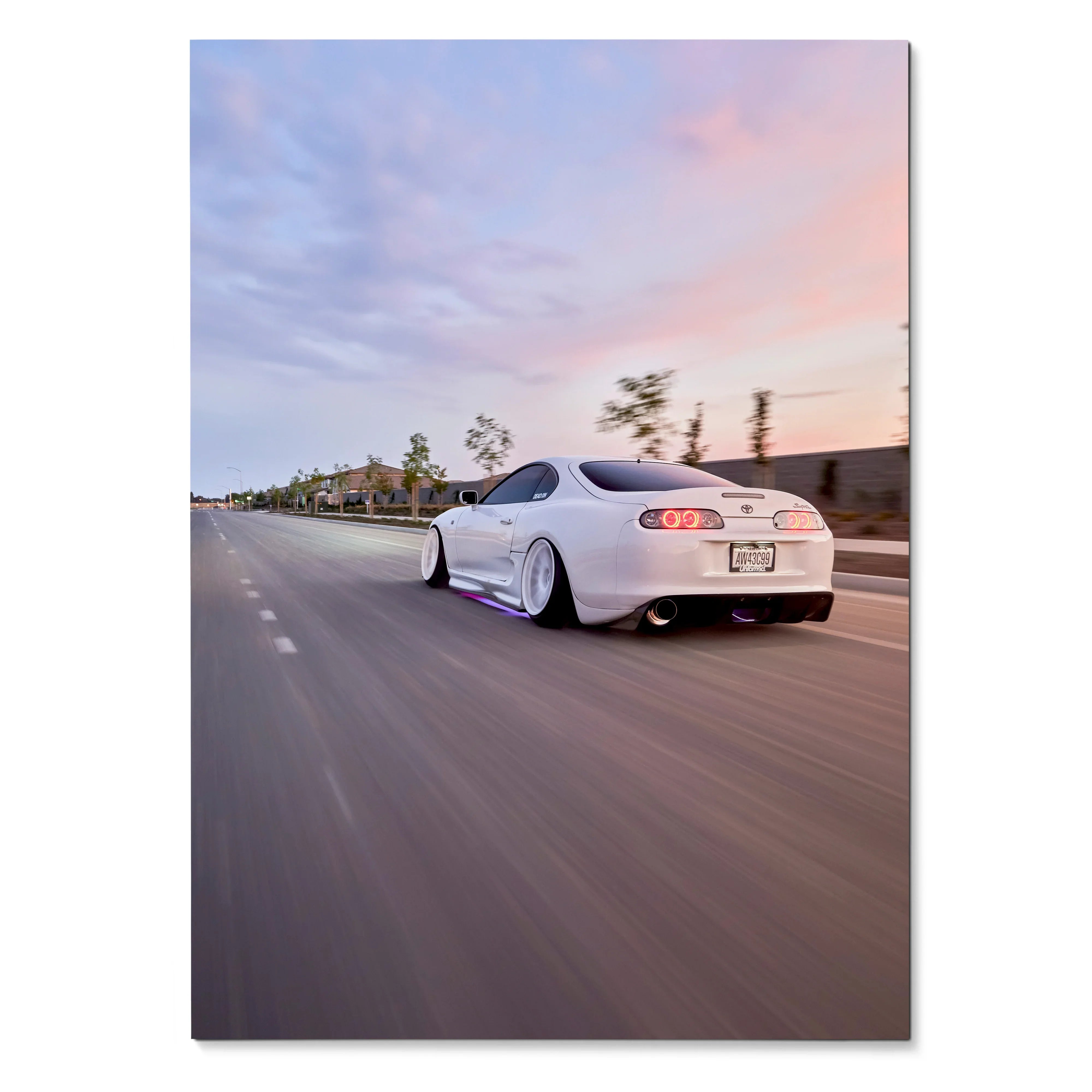 White Toyota Supra MK4 driving on road at sunset, vibrant poster wall art with blurred motion background.