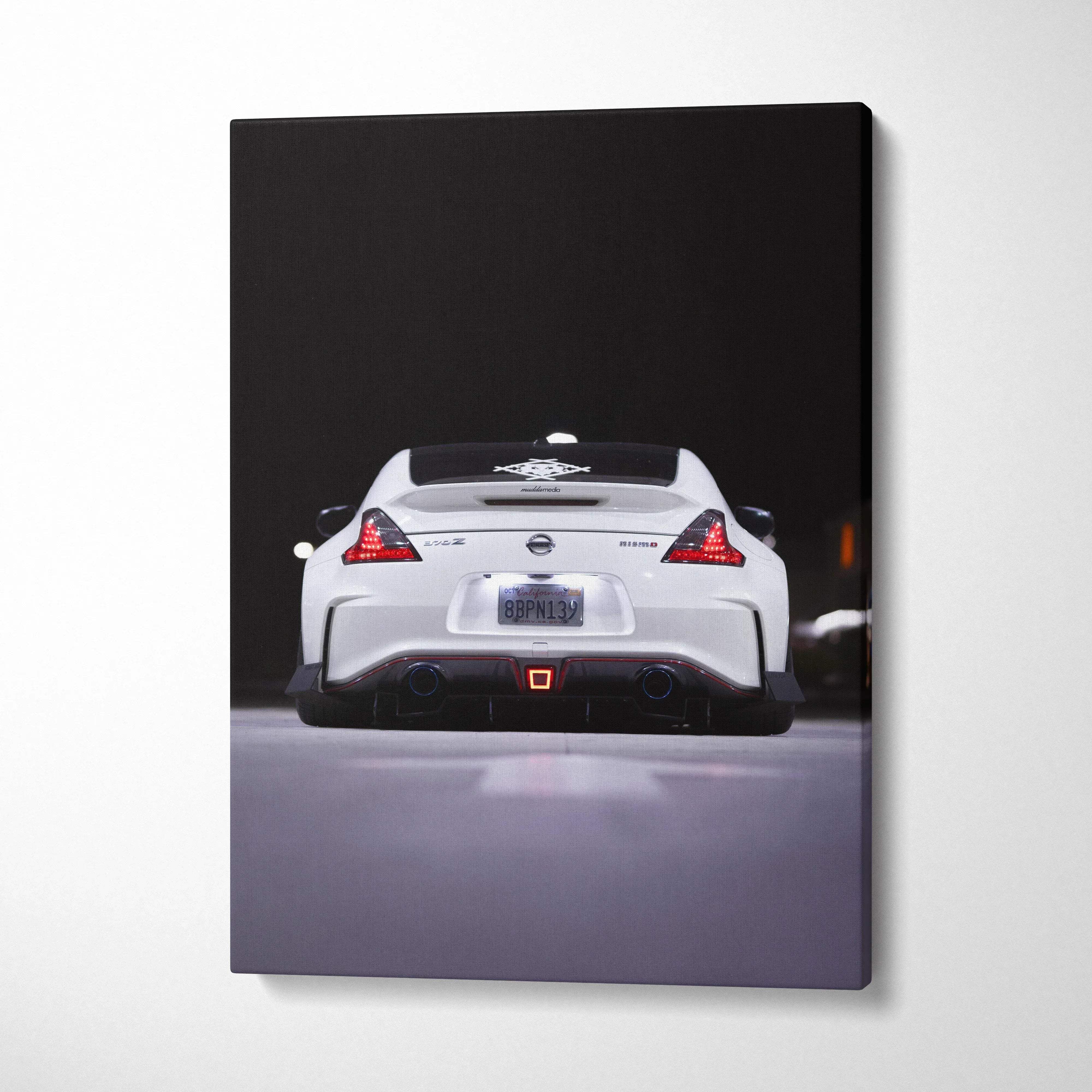 White Nissan 370z rear view on vertical black background canvas wall art.