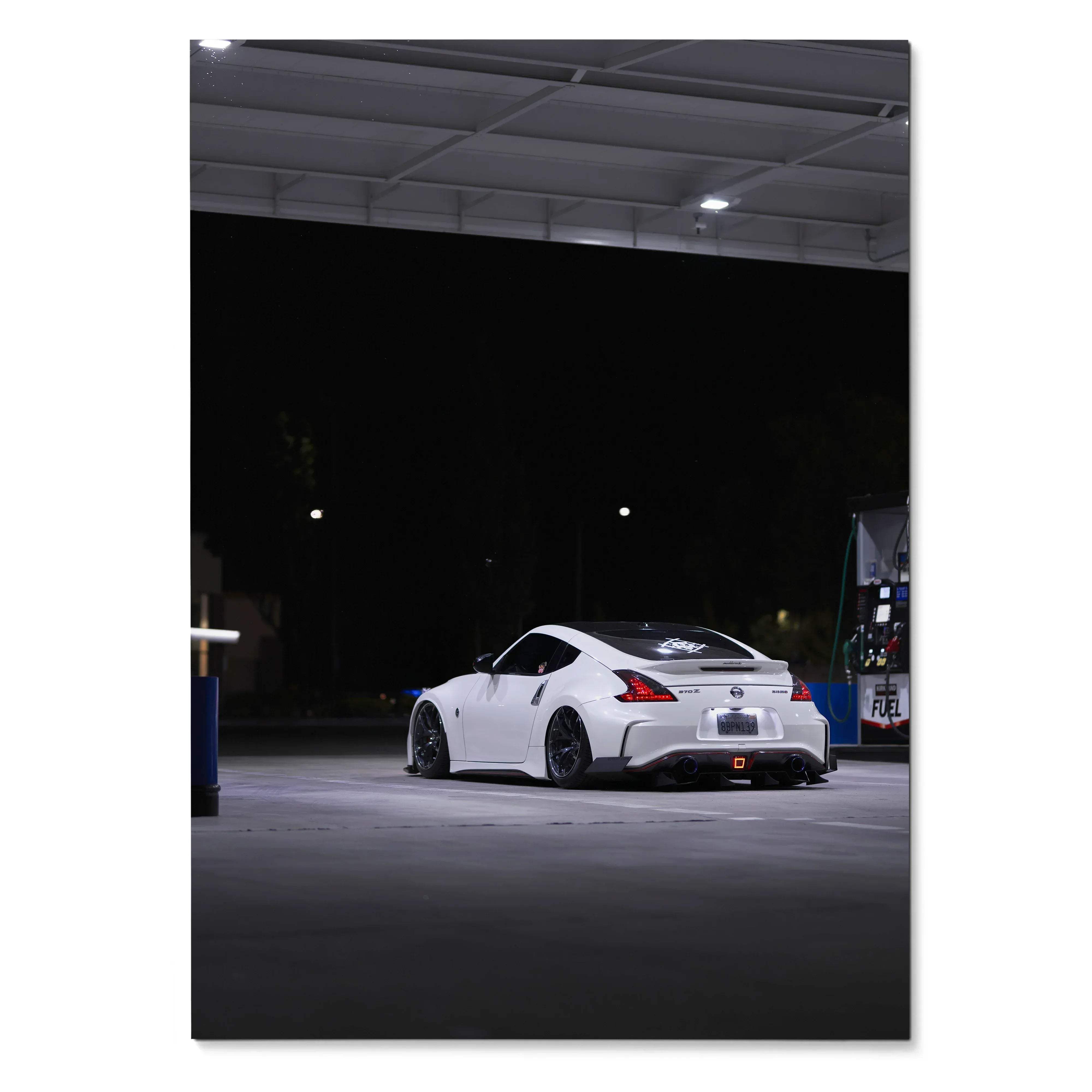 White Nissan Z34 370z parked under gas station lights at night poster wall art.