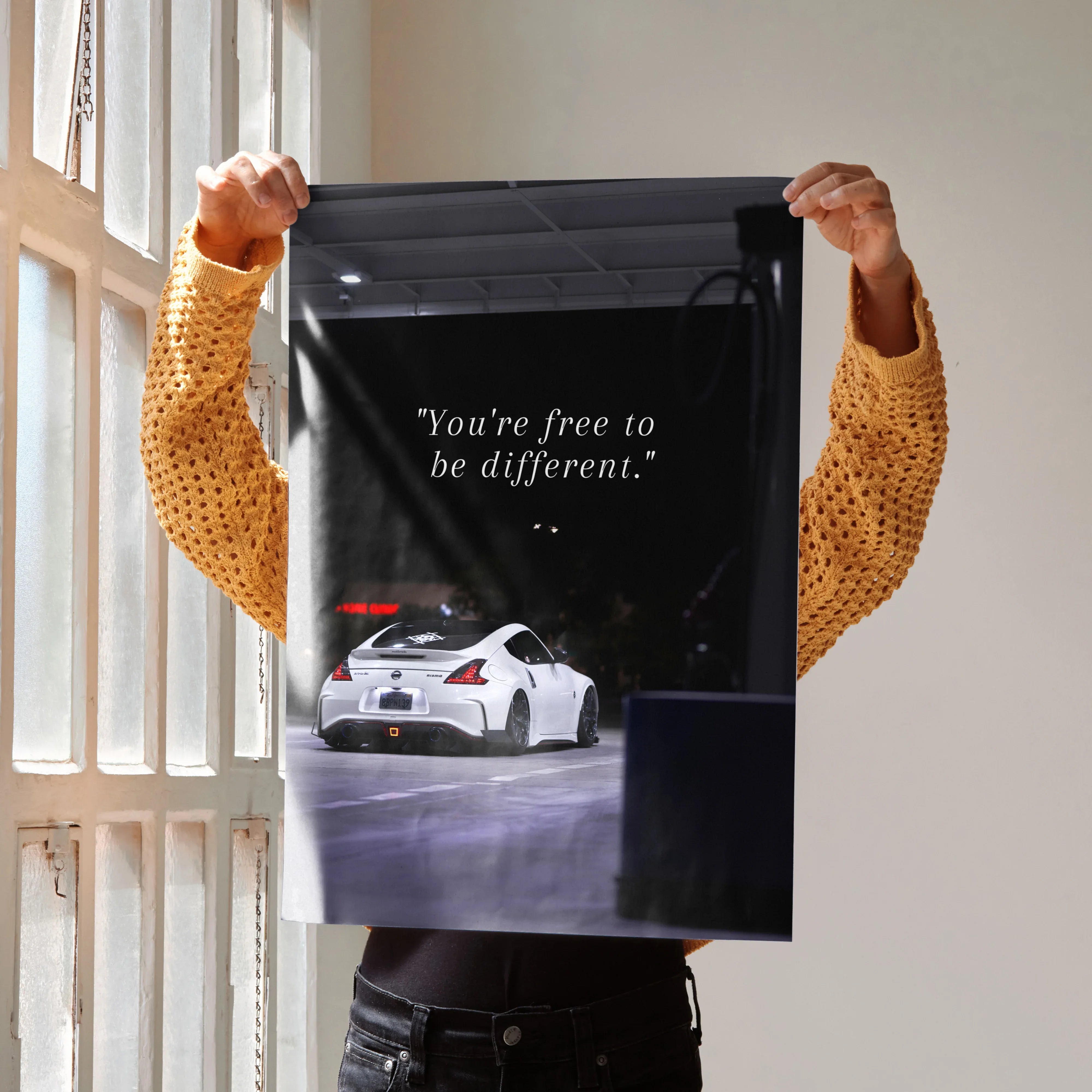 Motivational poster with white Nissan 370z and inspiring text on black background wall art.