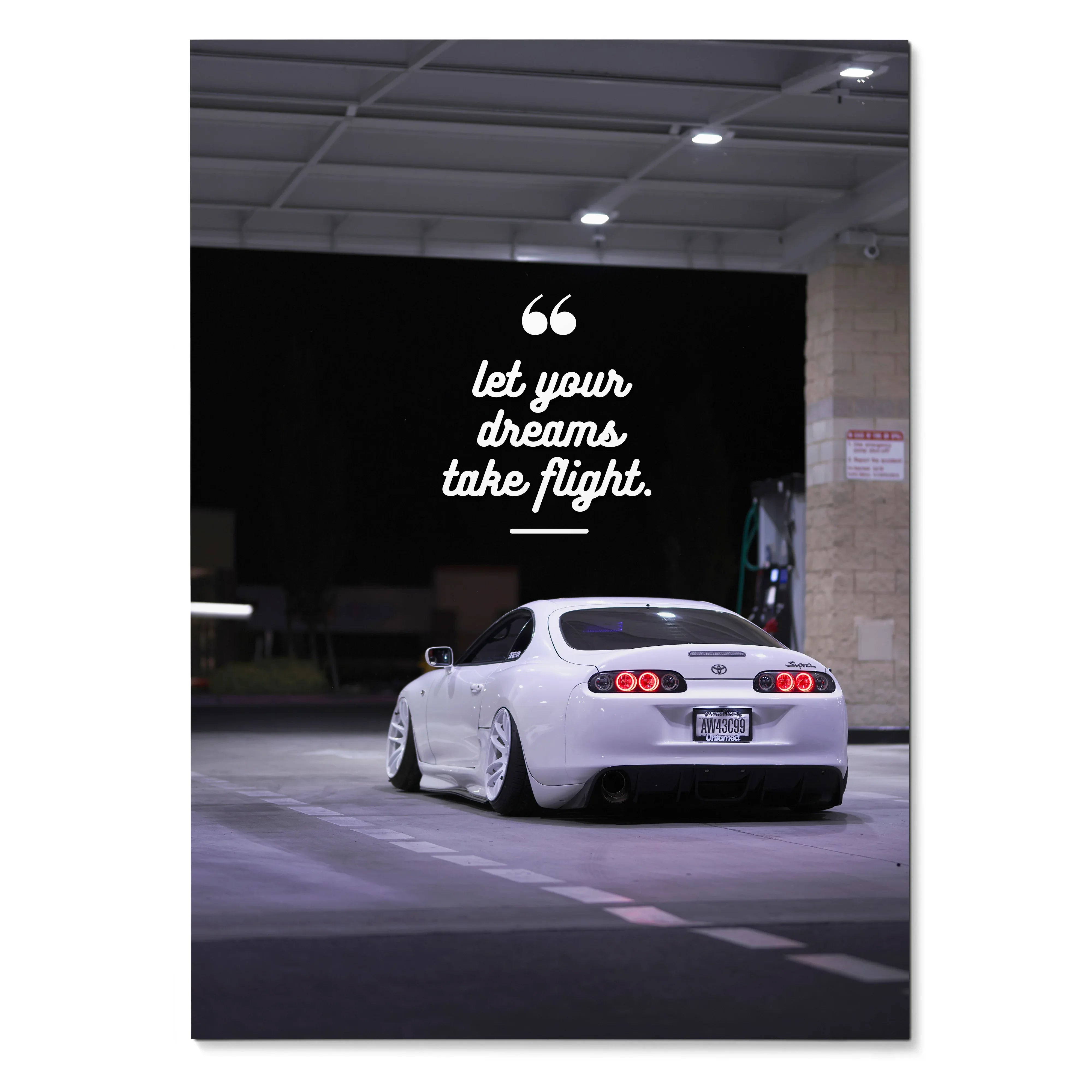 Toyota Supra Mk4 poster wall art with white sports car and "let your dreams take flight" text on black background.