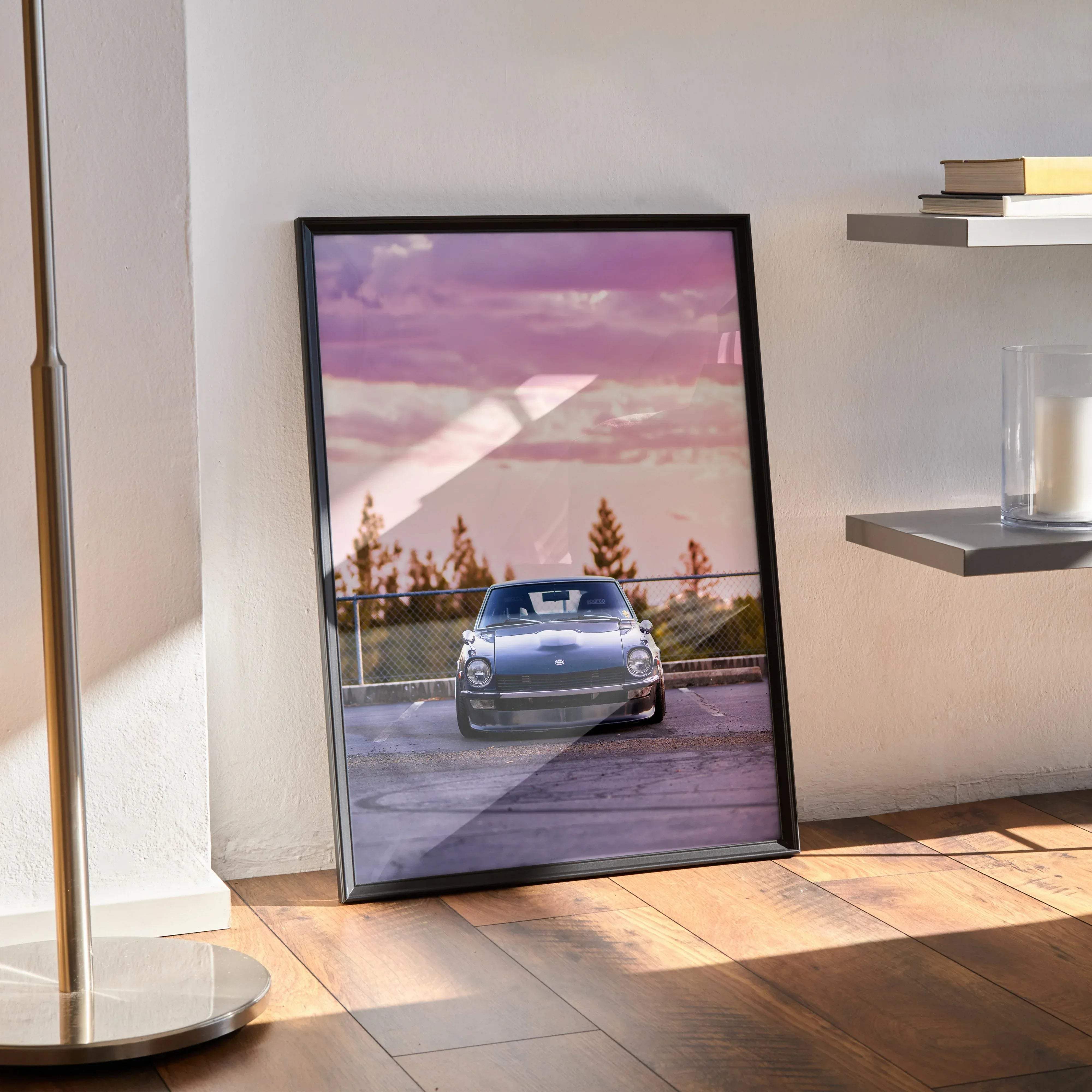 Black-framed Nissan 240z high resolution car poster featuring a silver Porsche sports car under pink and purple sky