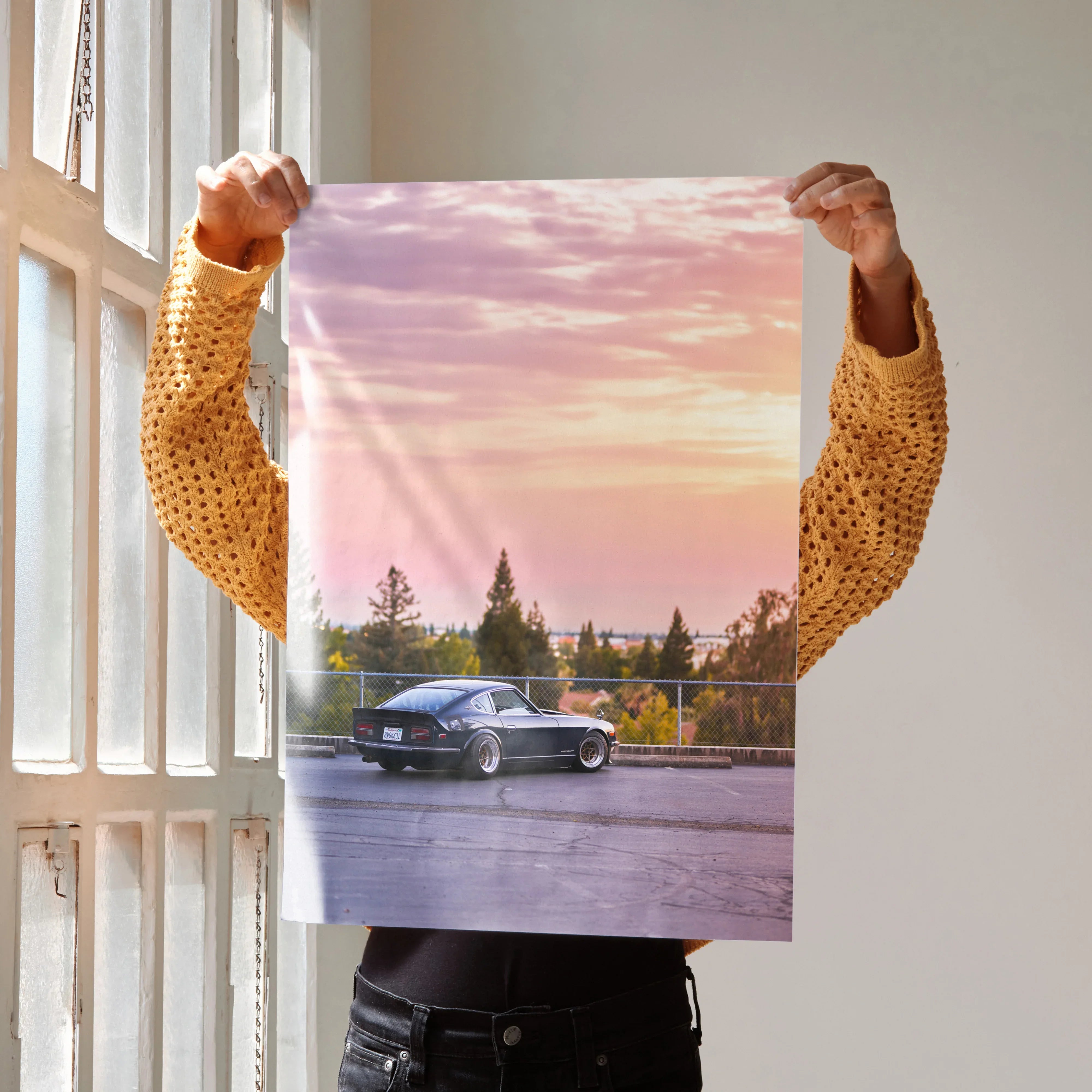 Nissan 240z car poster with sunset sky in the background, stylish wall art for car enthusiasts.
