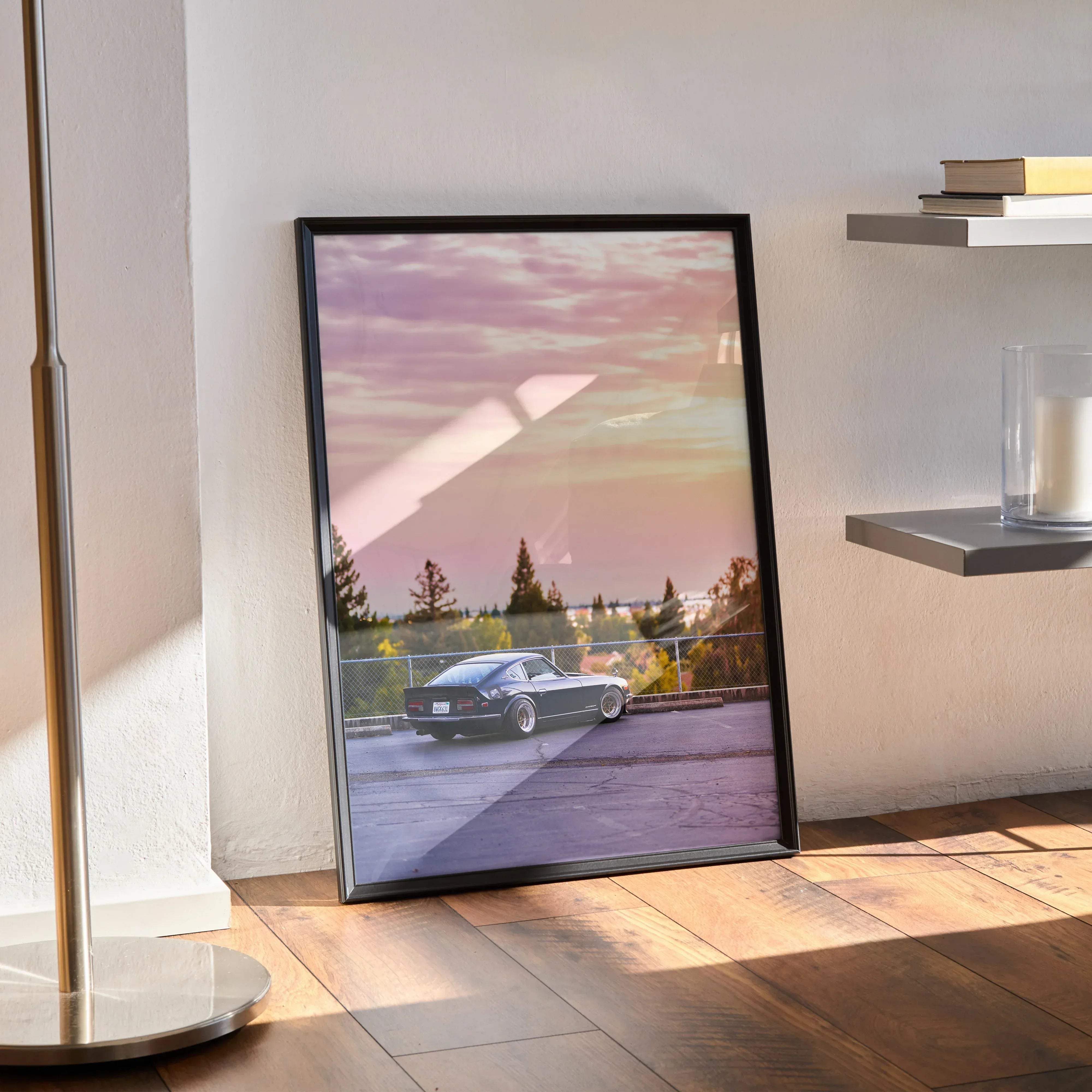 Black framed poster featuring a classic black nissan 240z sports car under a pink and purple sunset sky