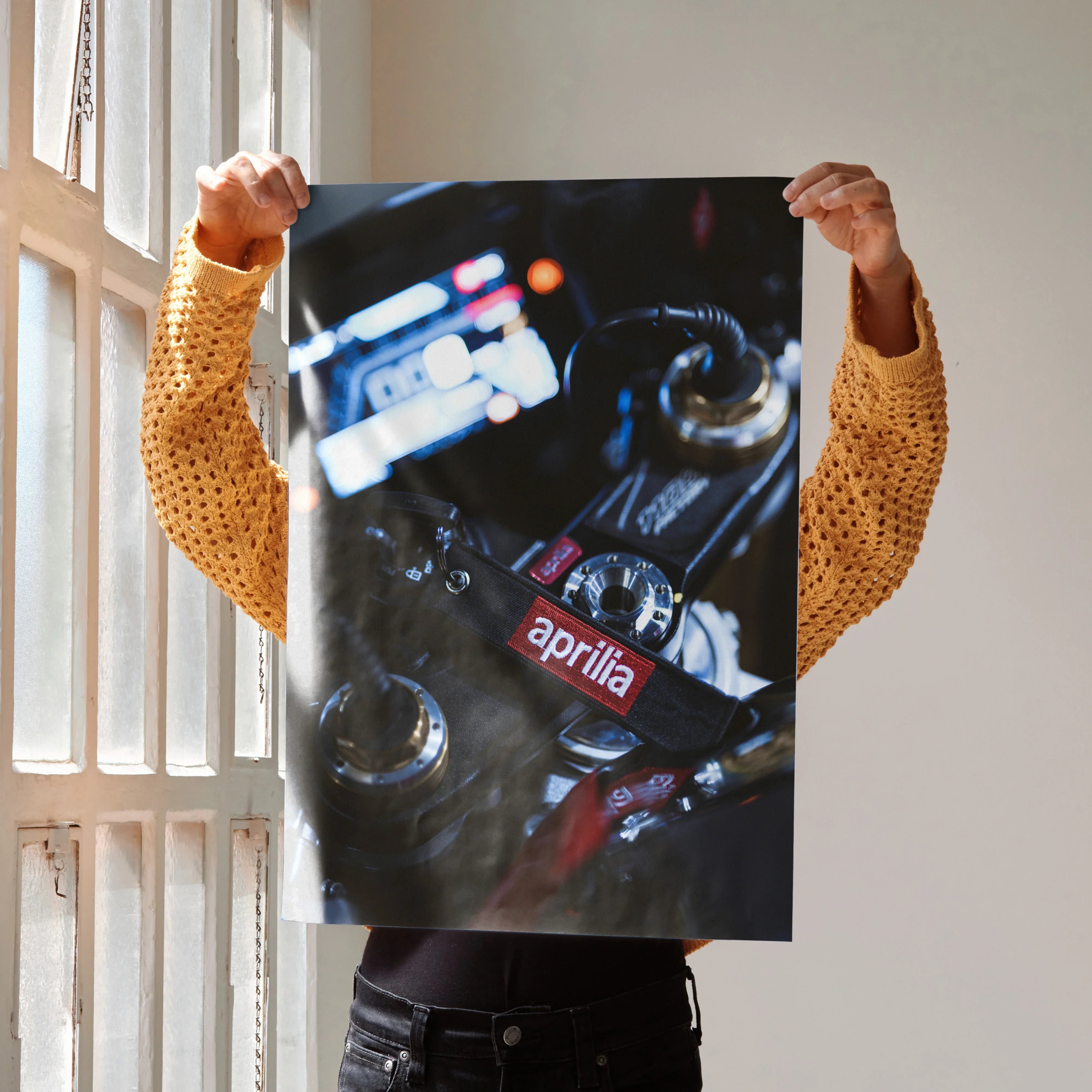 Aprilia RSV4 1100 Factory motorcycle close-up poster wall art held by person in yellow sweater.