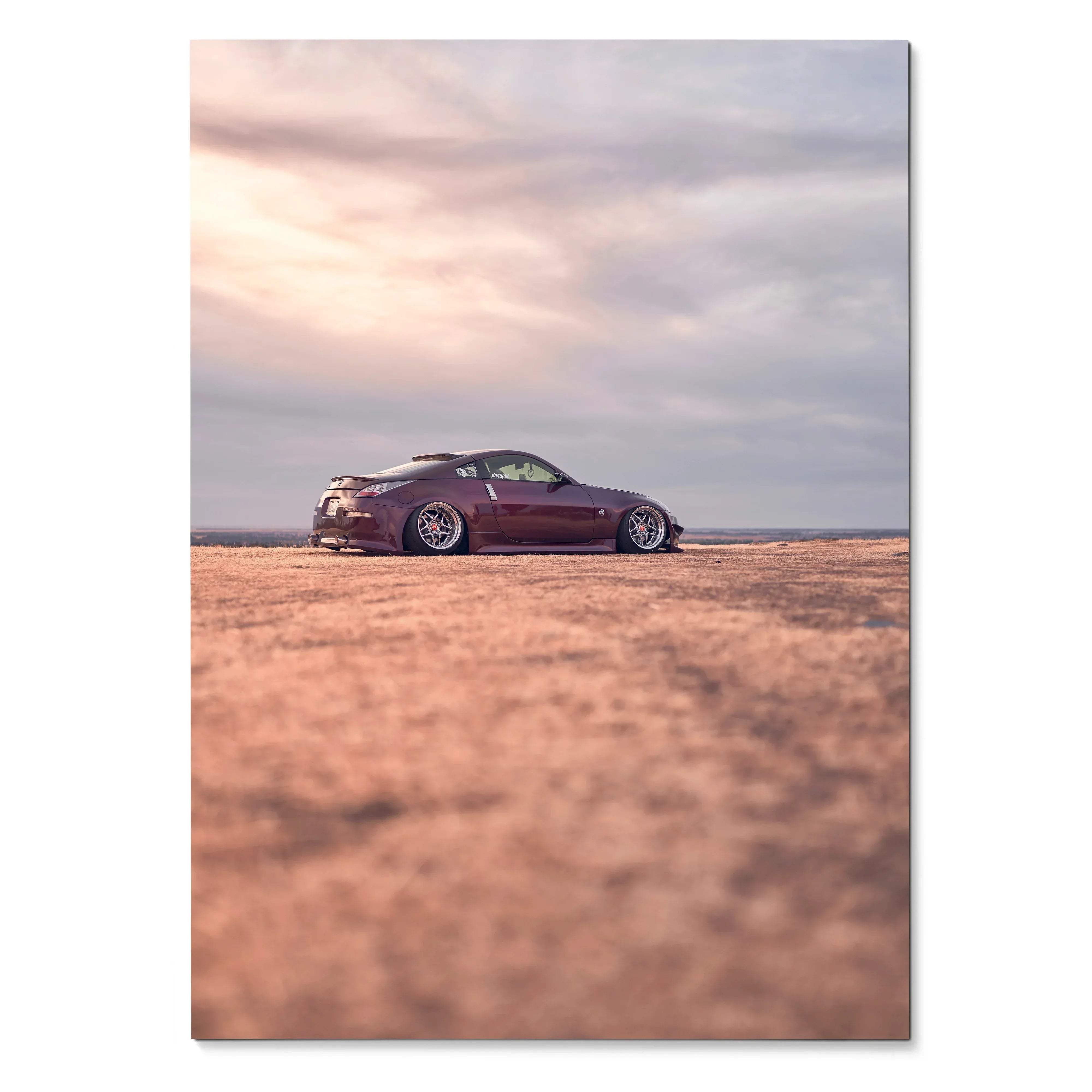 Nissan 350z parked on textured ground under cloudy sky poster wall art.