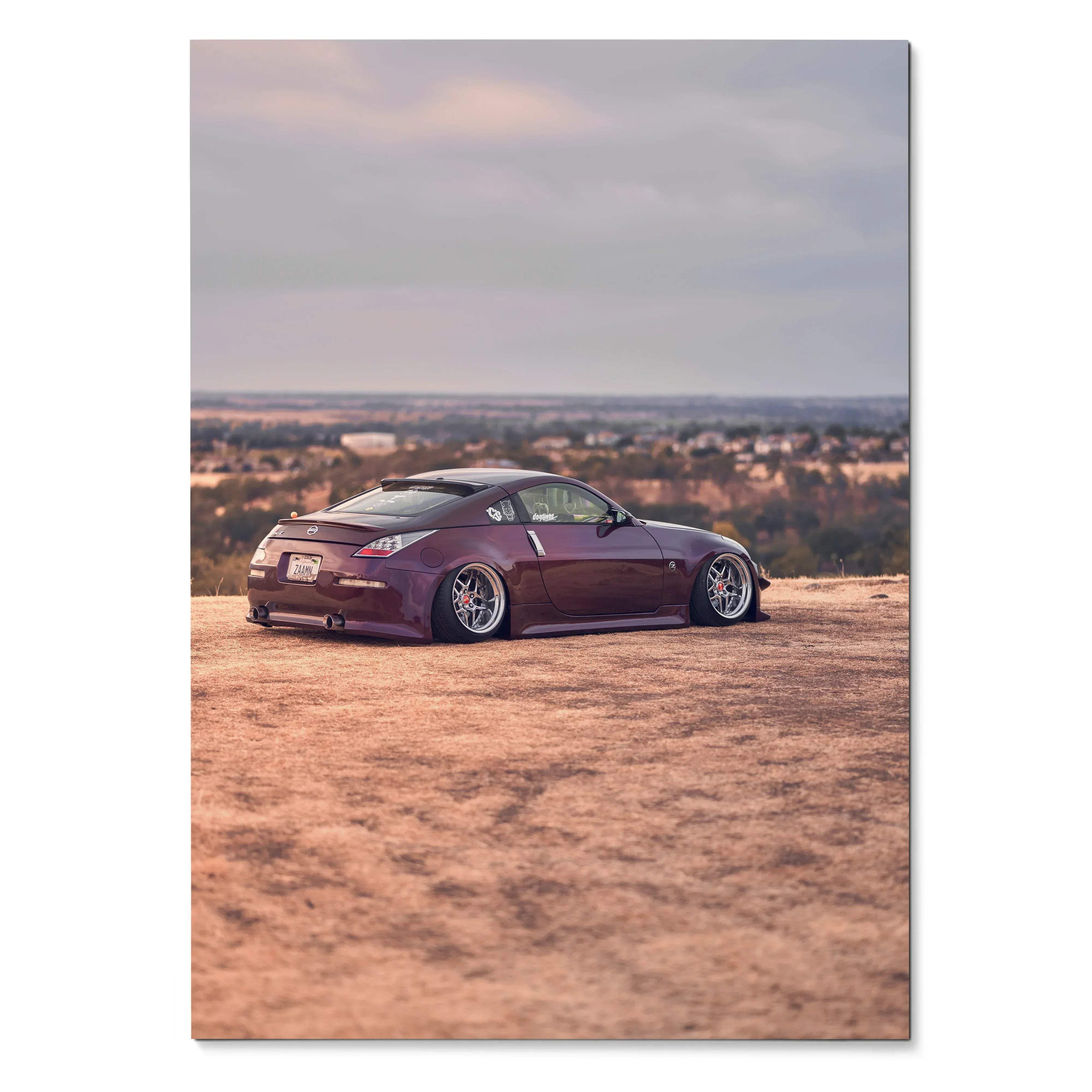 Purple Nissan 350z lowered on dirt ground with cityscape background poster wall art.