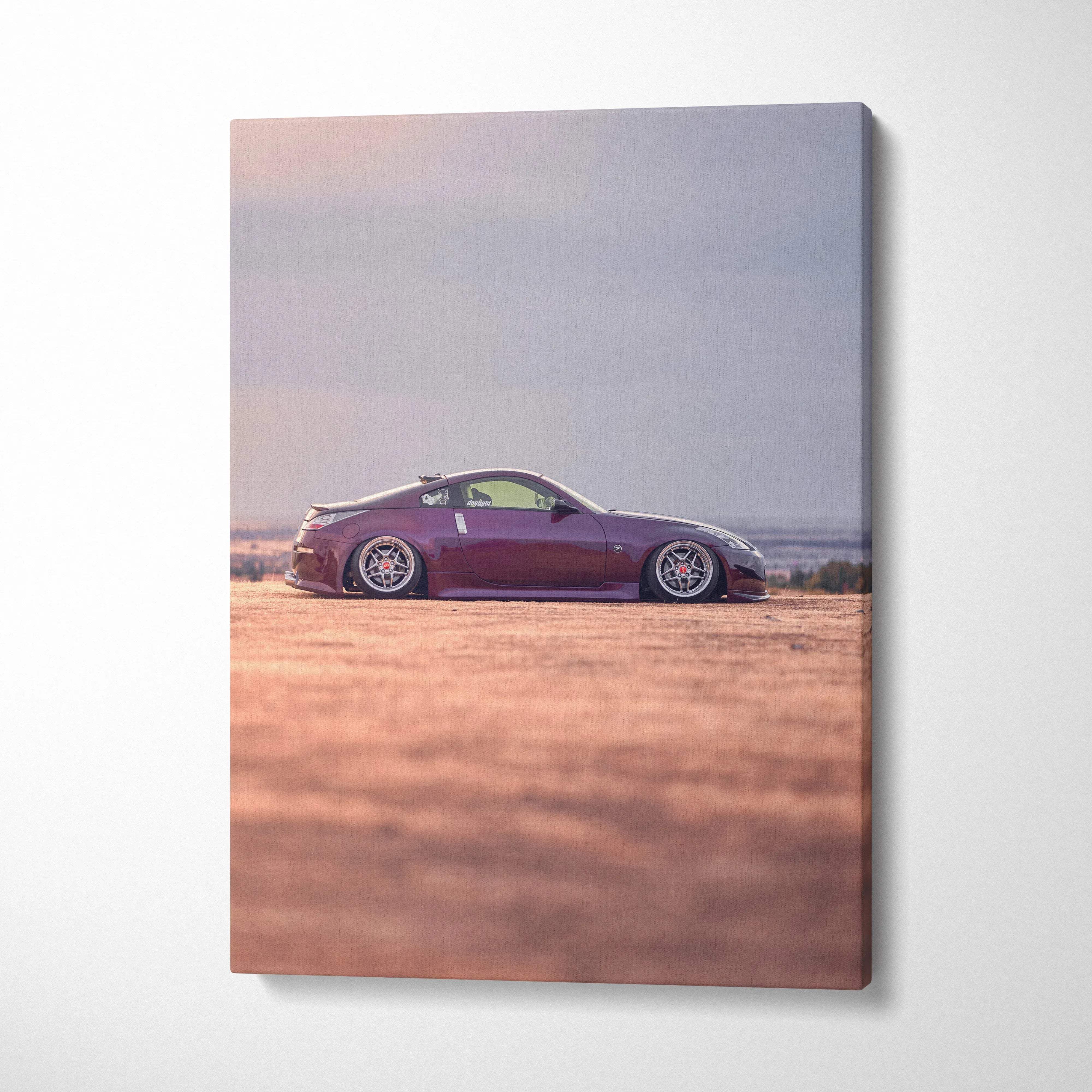 Vertical canvas art of a maroon Nissan 350z parked on a sandy terrain with a soft sky background.