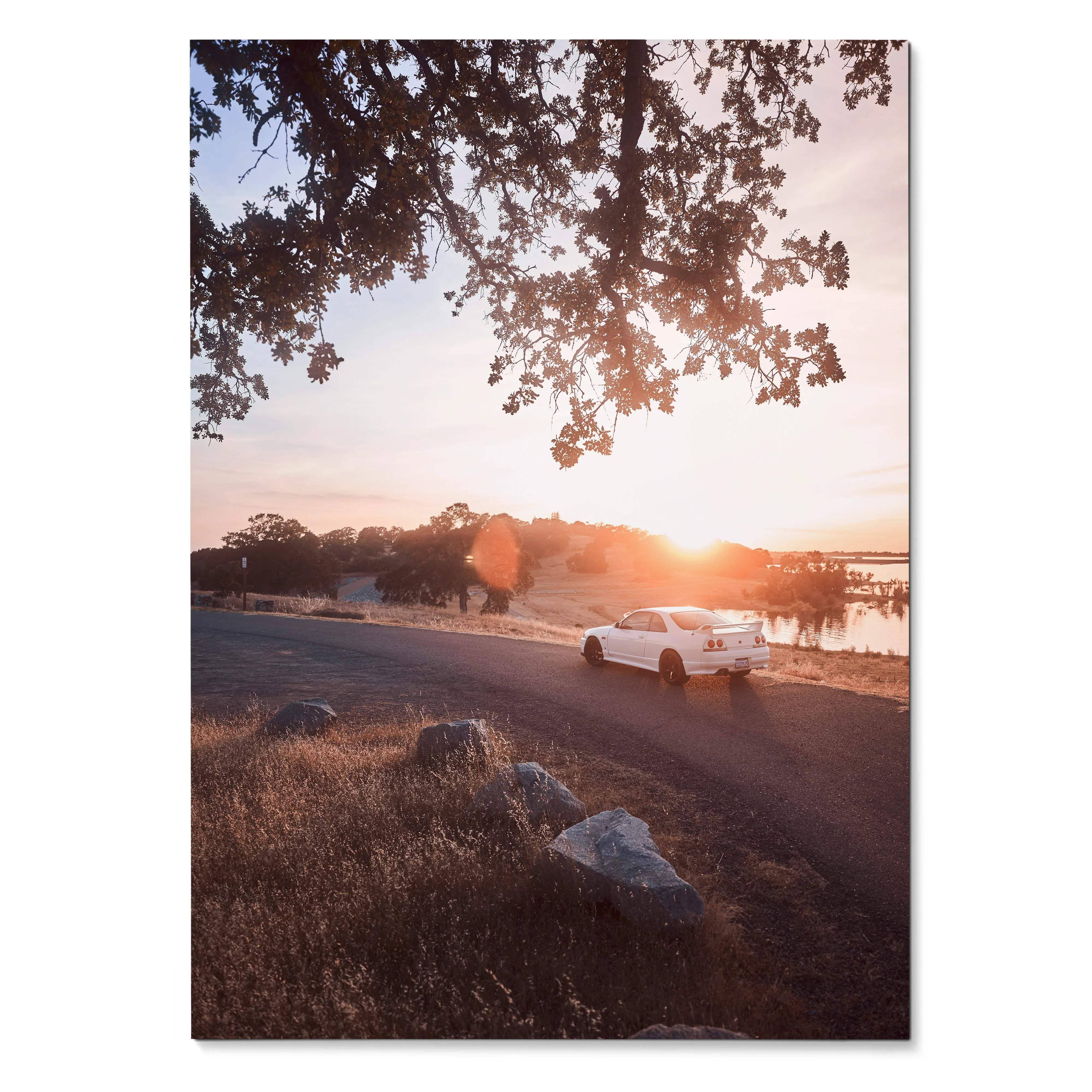 Nissan Skyline R33 GTS-T driving on coastal road at sunset Poster wall art with warm sky tones.