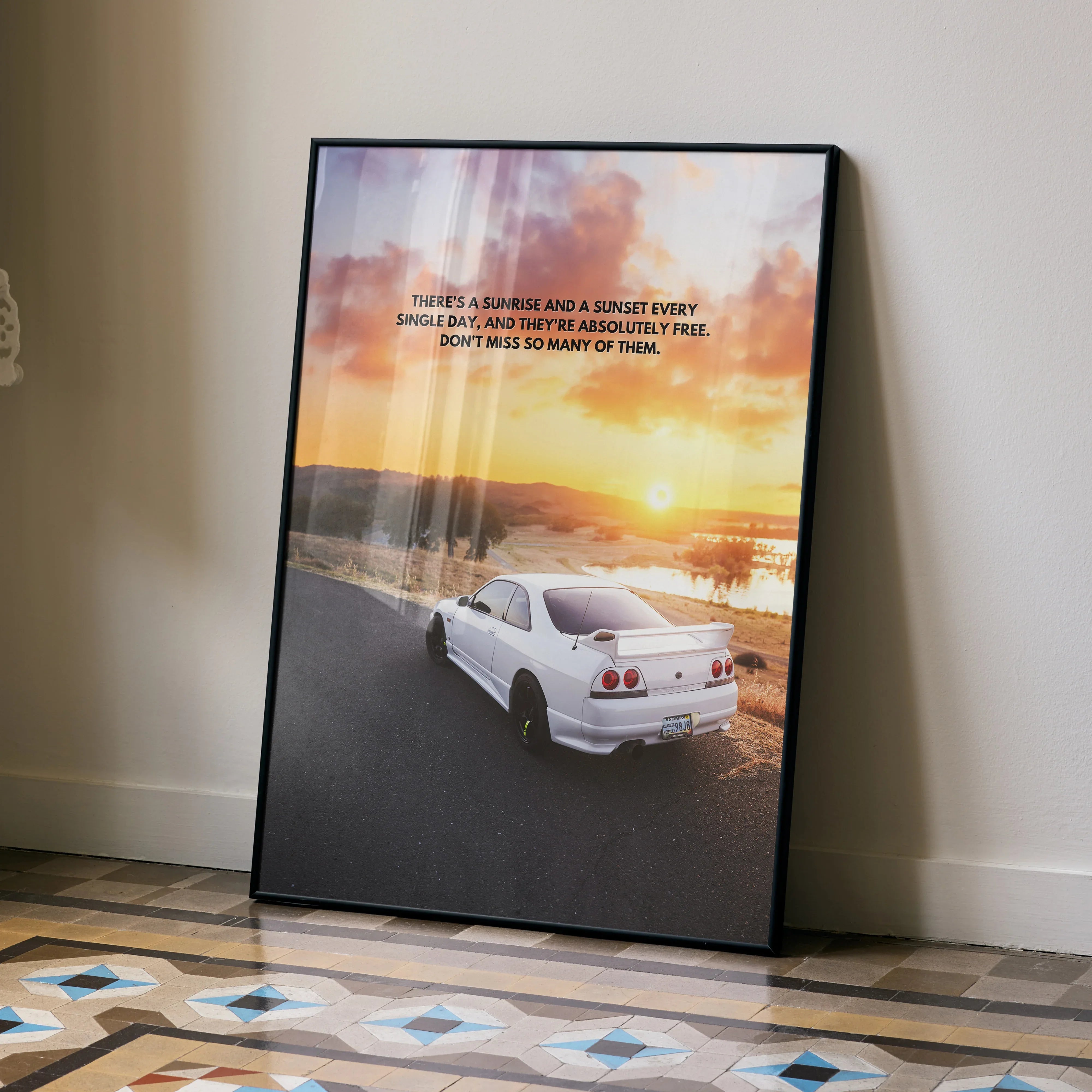 Motivational poster wall art featuring white Nissan R33 Skyline GTS-T on sunset coastal road.