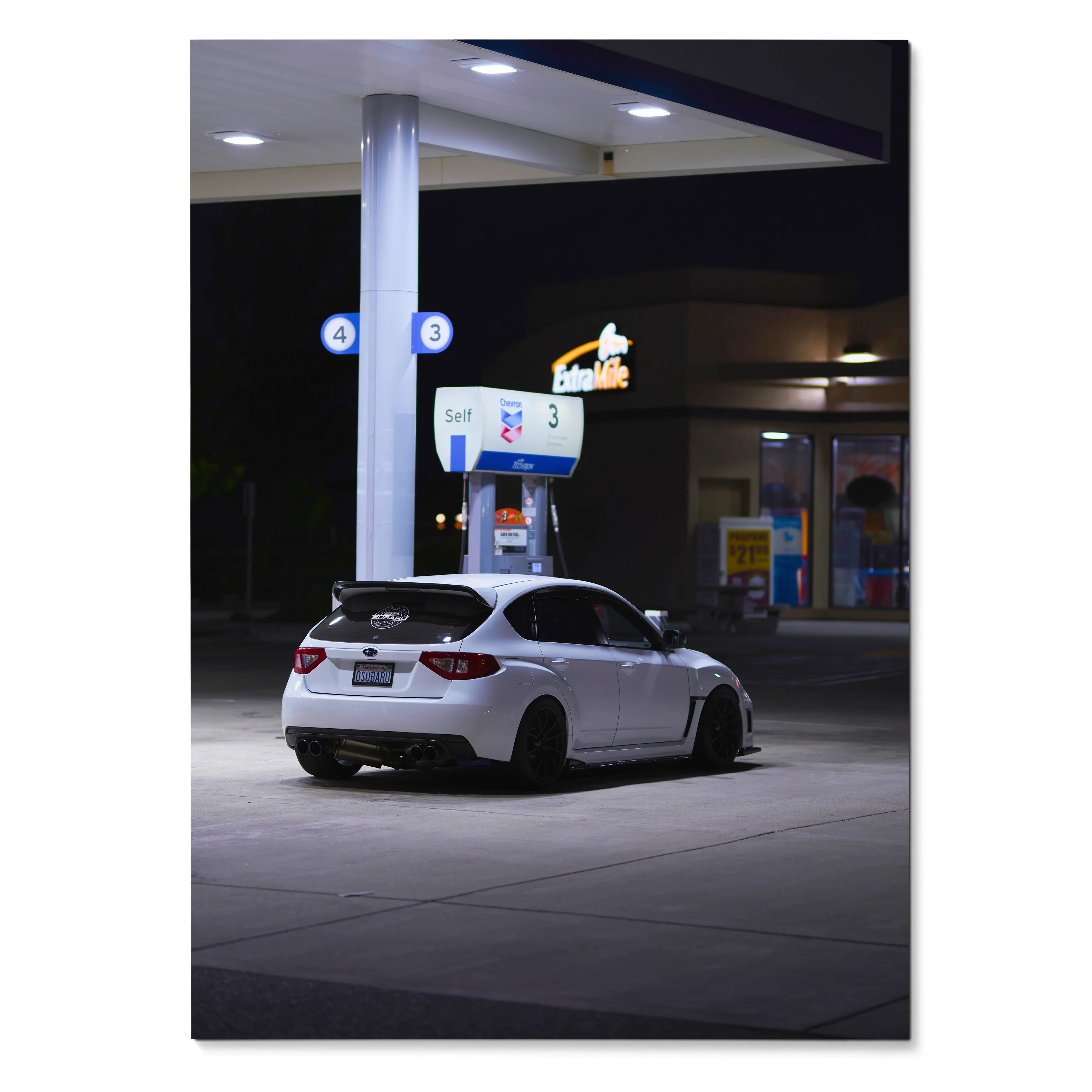 White Subaru WRX STI parked at nighttime gas station poster wall art.