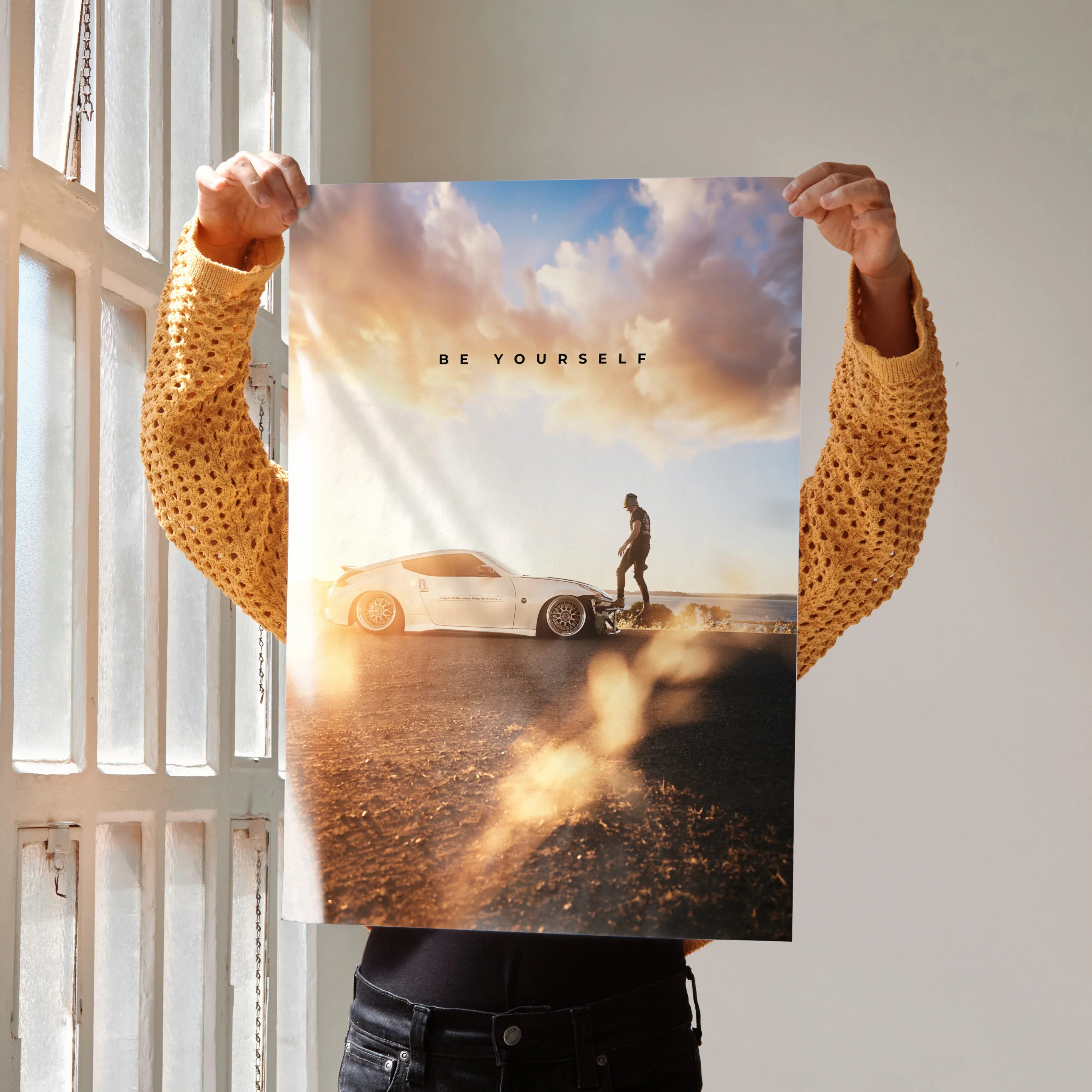 Motivational Nissan 370z poster with sunset background and lone figure in warm tones wall art.