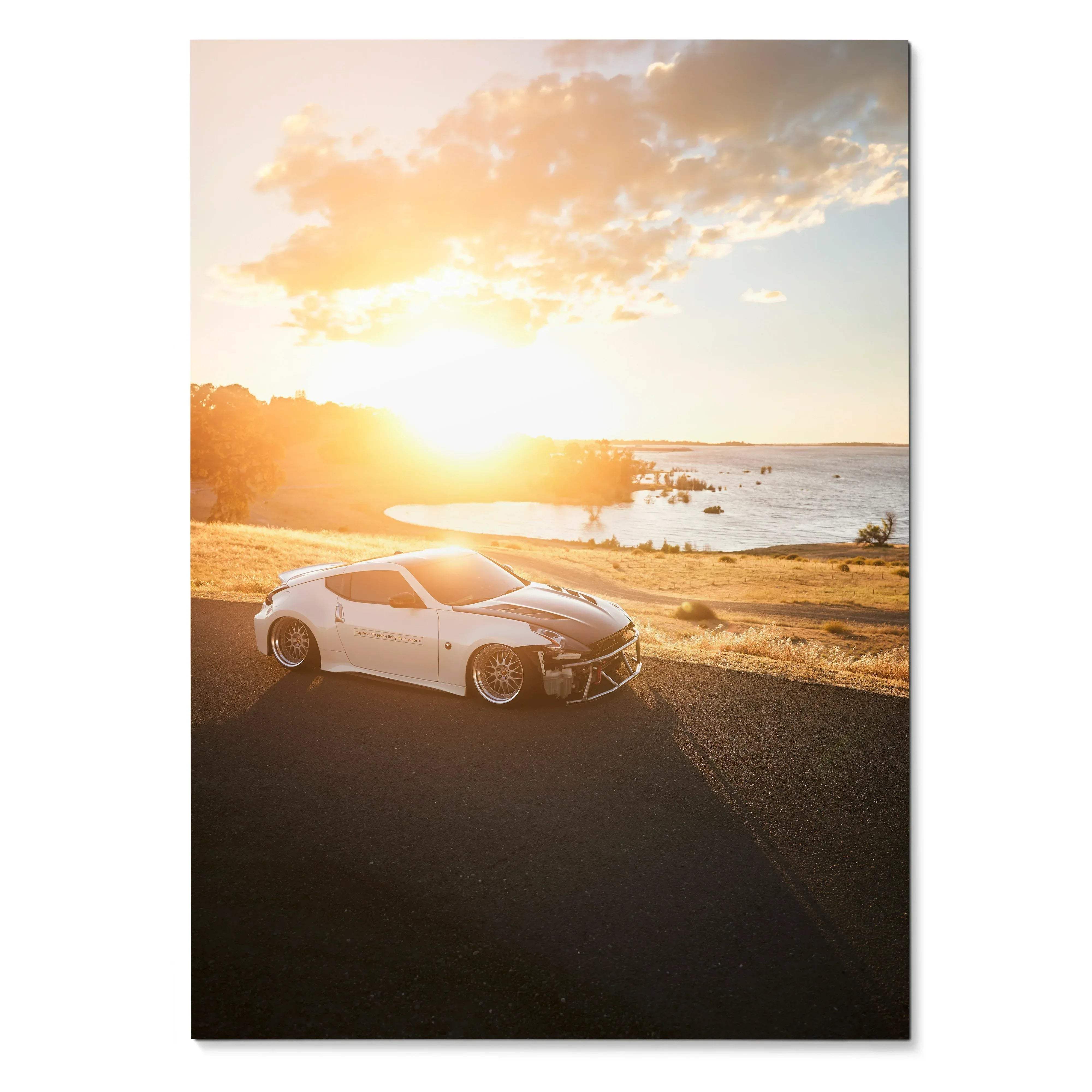Nissan 370z sports car parked on coastal road at sunset poster wall art with warm sky colors.