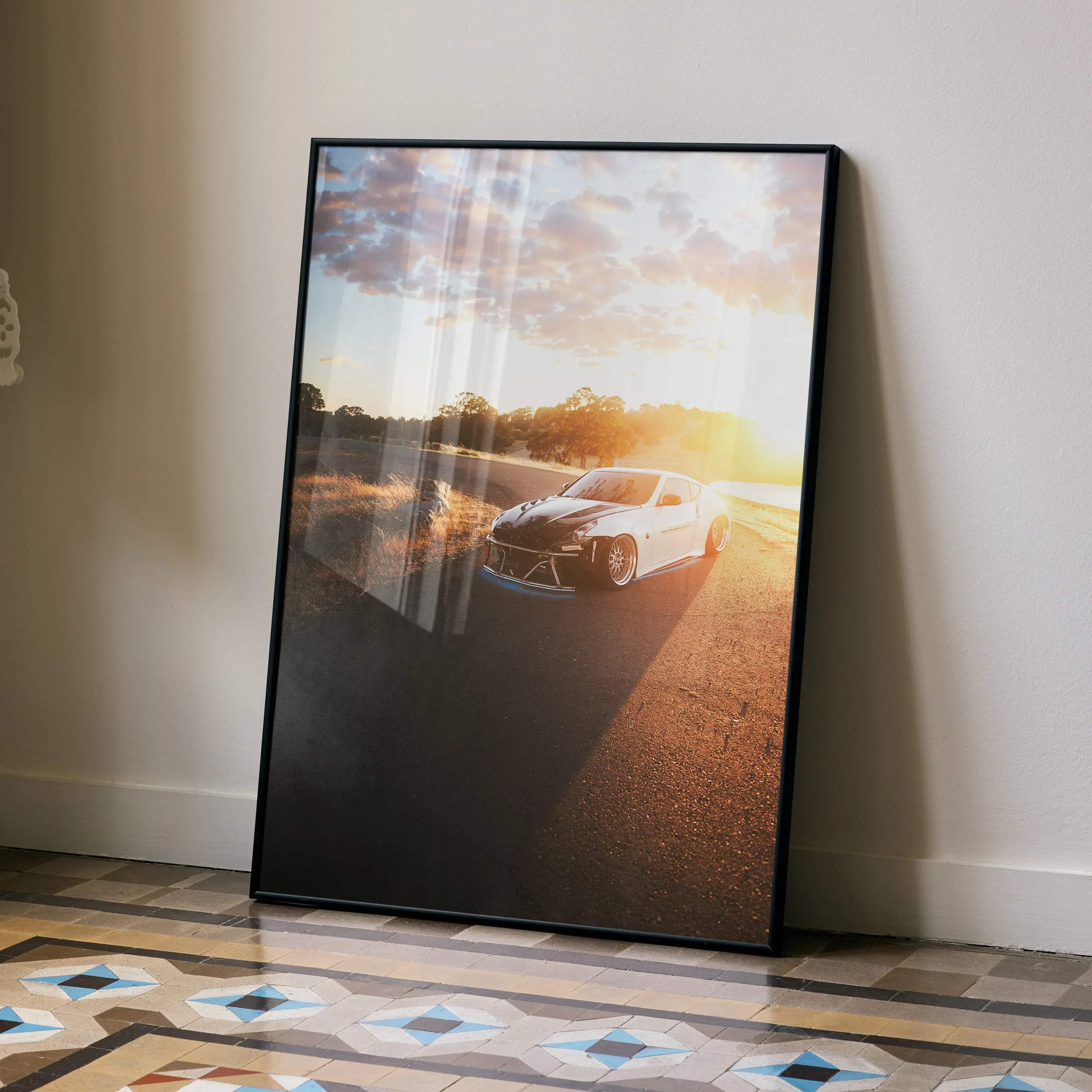 Black-framed poster featuring a white Nissan 370z sports car under golden sunset light high resolution car poster
