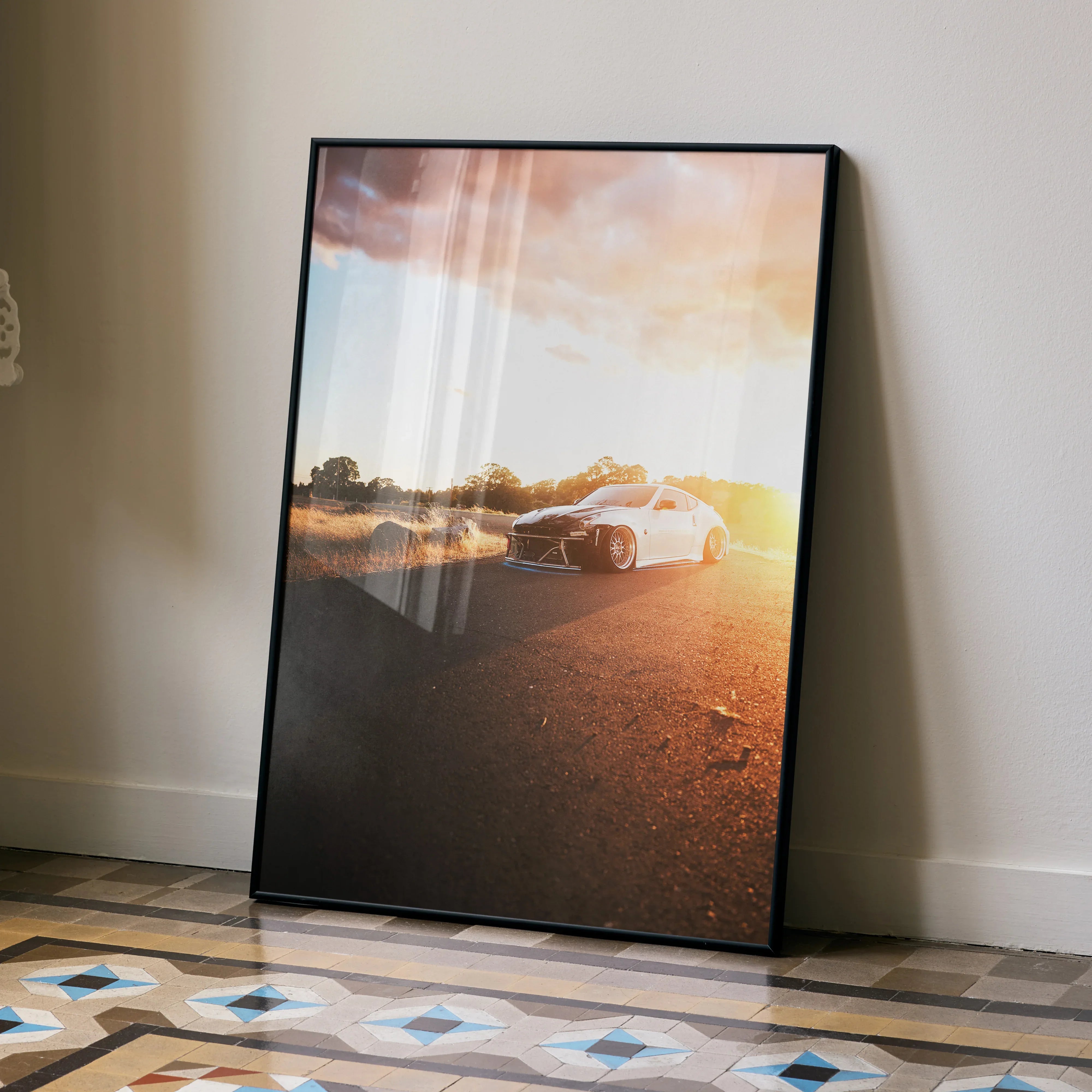 Nissan 370z sleek white car at sunset on road poster wall art in black frame.