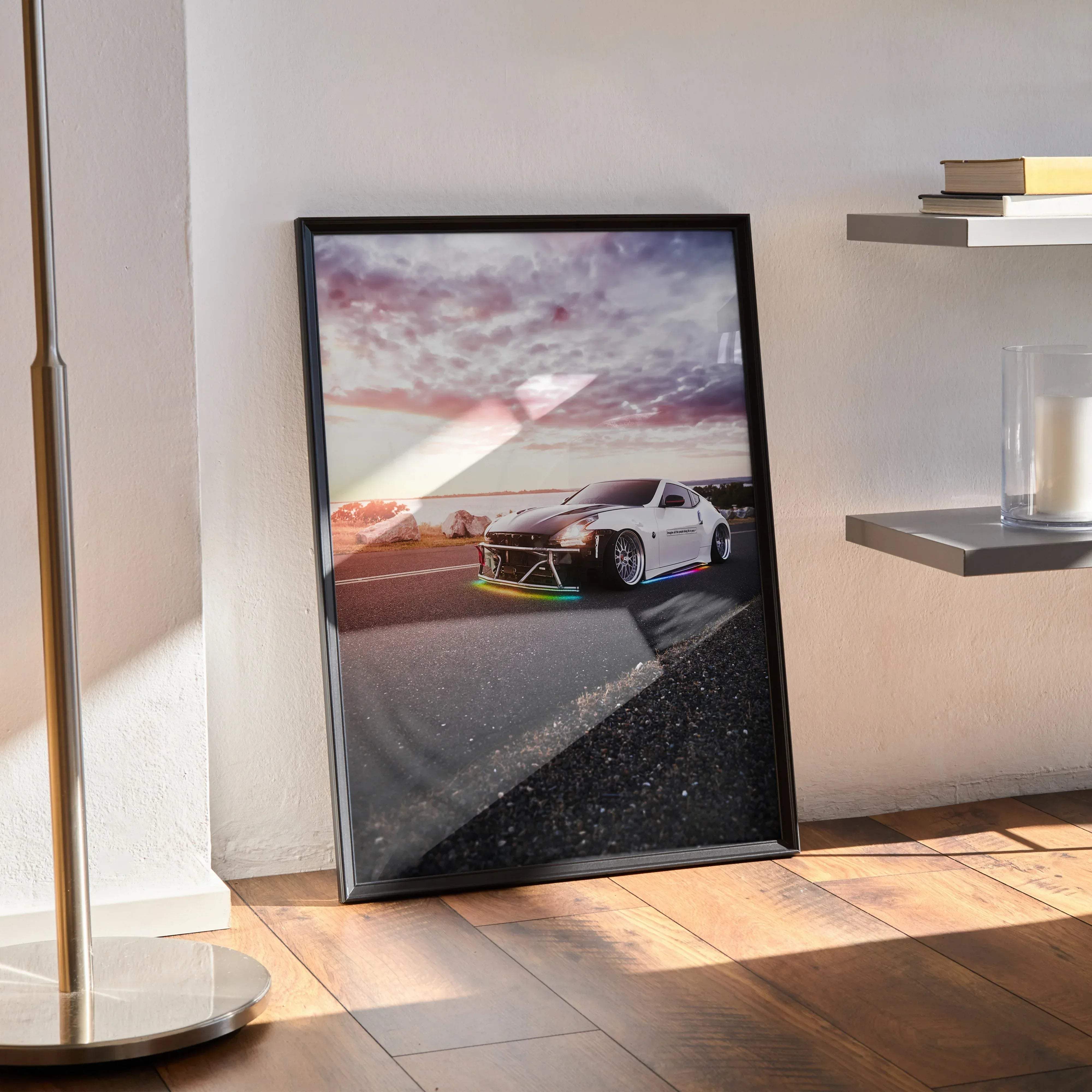 Black-framed poster of a white Nissan 370z sports car with rainbow LED chassis lights against a sunset sky