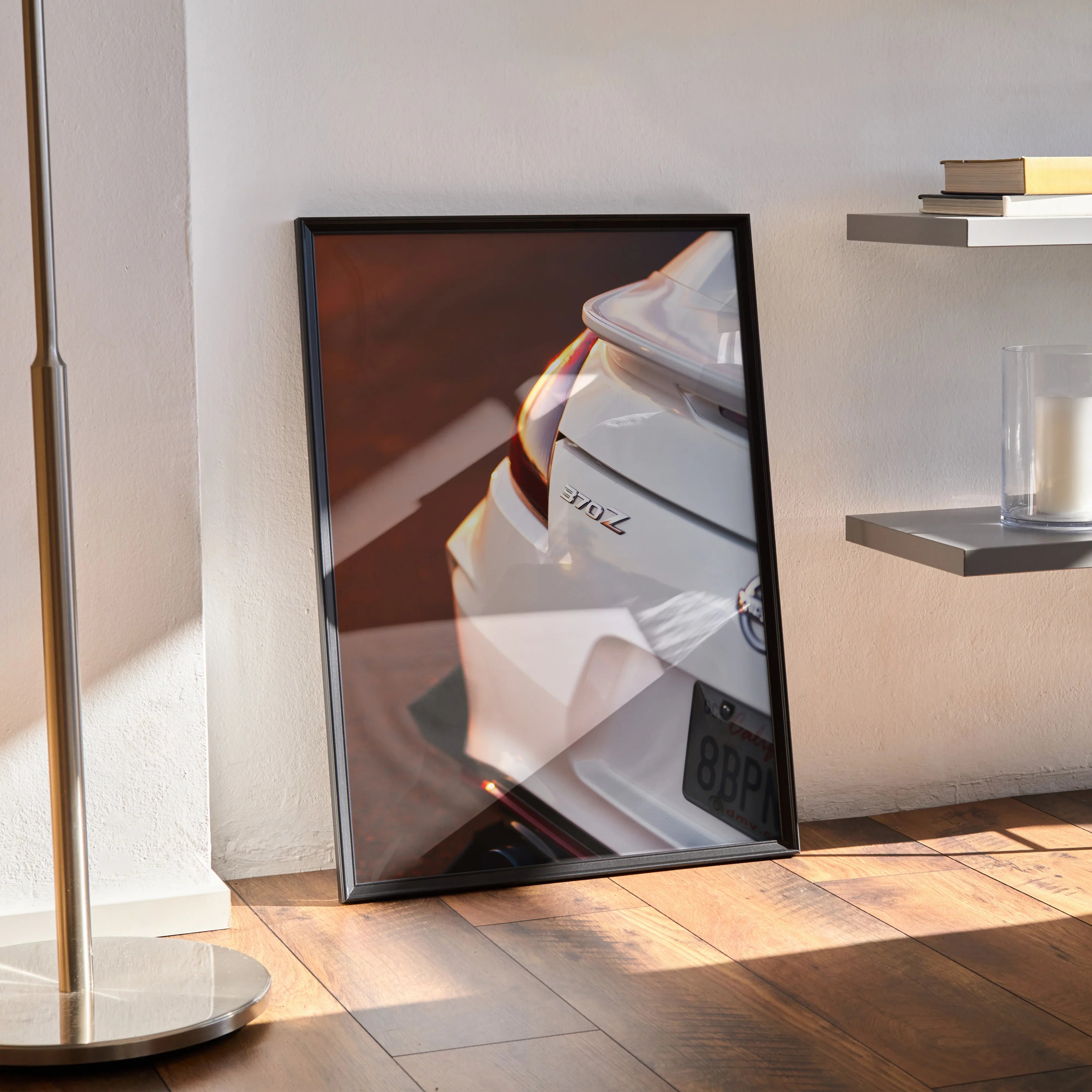 Nissan 370z rear close-up poster wall art in sleek black frame leaning against wall.
