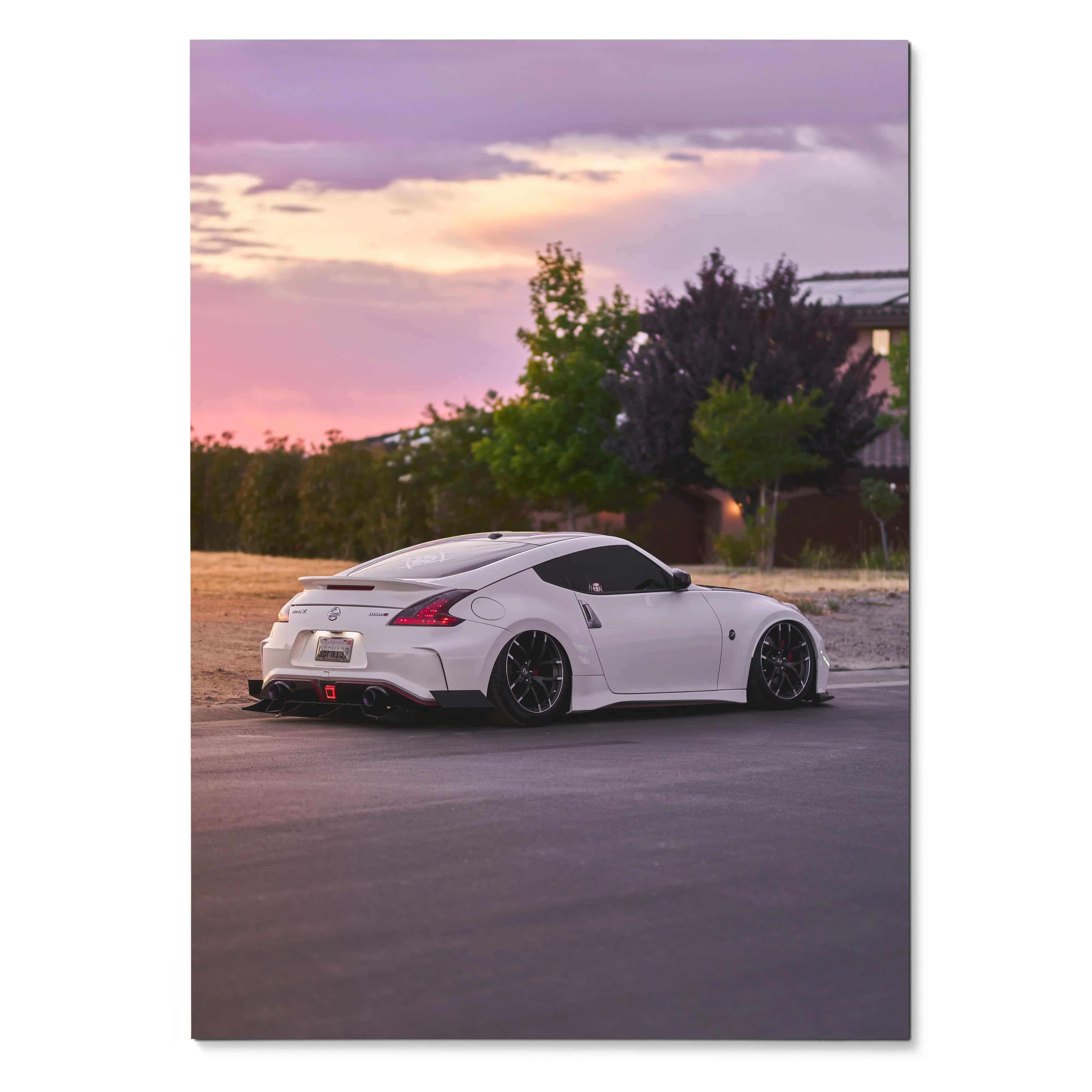 White Nissan 370z parked at sunset with purple sky poster wall art.