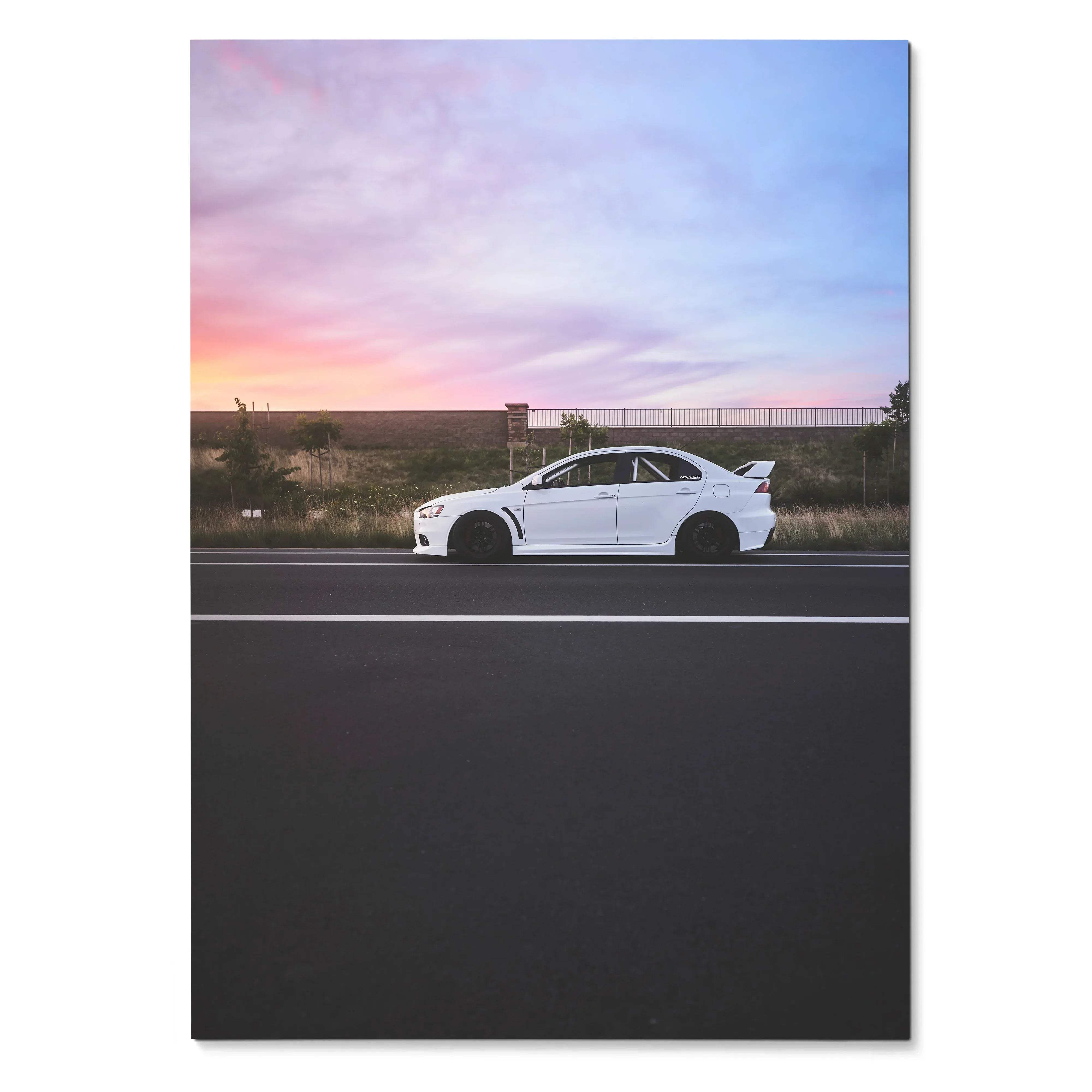 Mitsubishi Evo X in white on road at sunset with vibrant sky poster wall art.