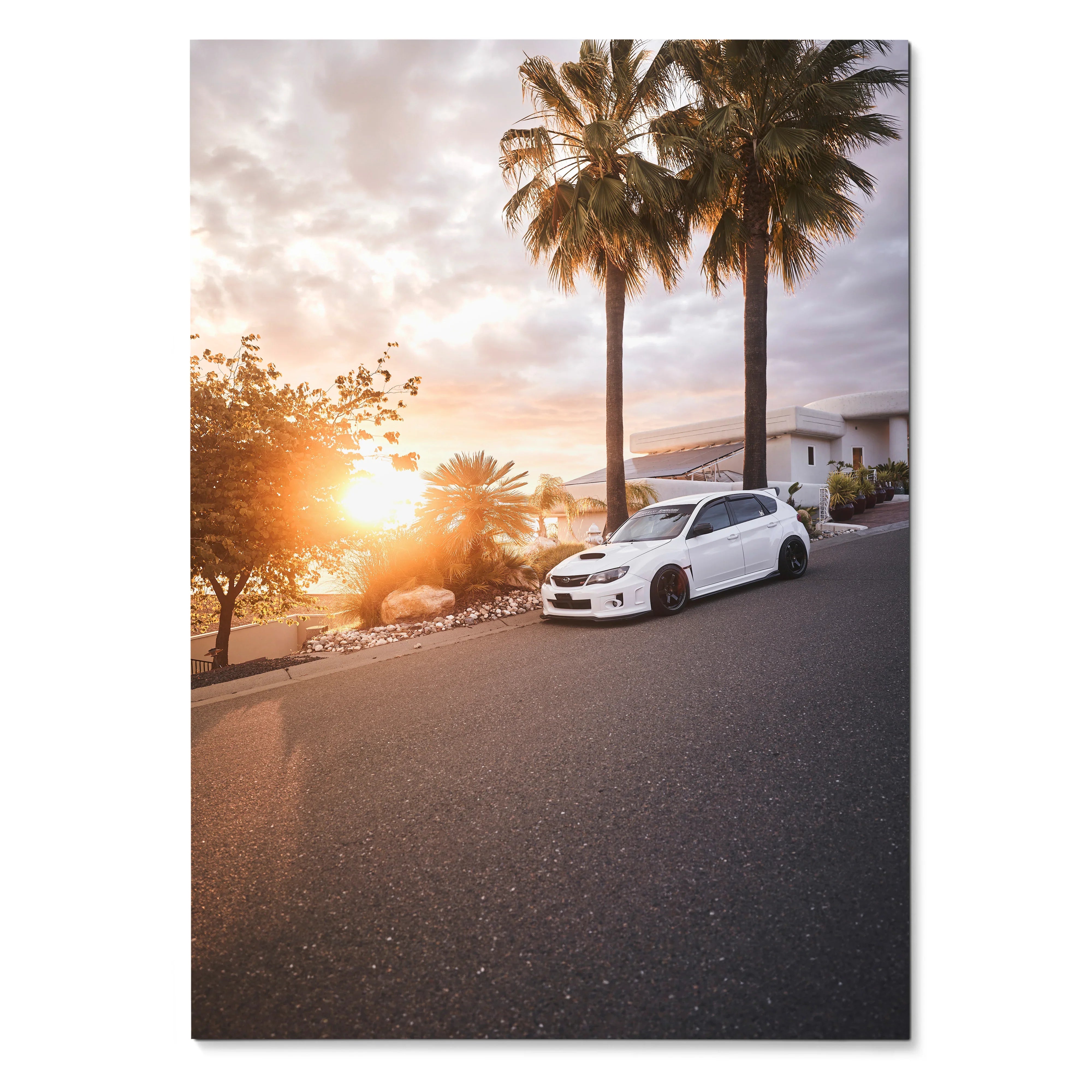 Subaru WRX STI poster featuring white car parked on road at sunset with palm trees and scenic background wall art.
